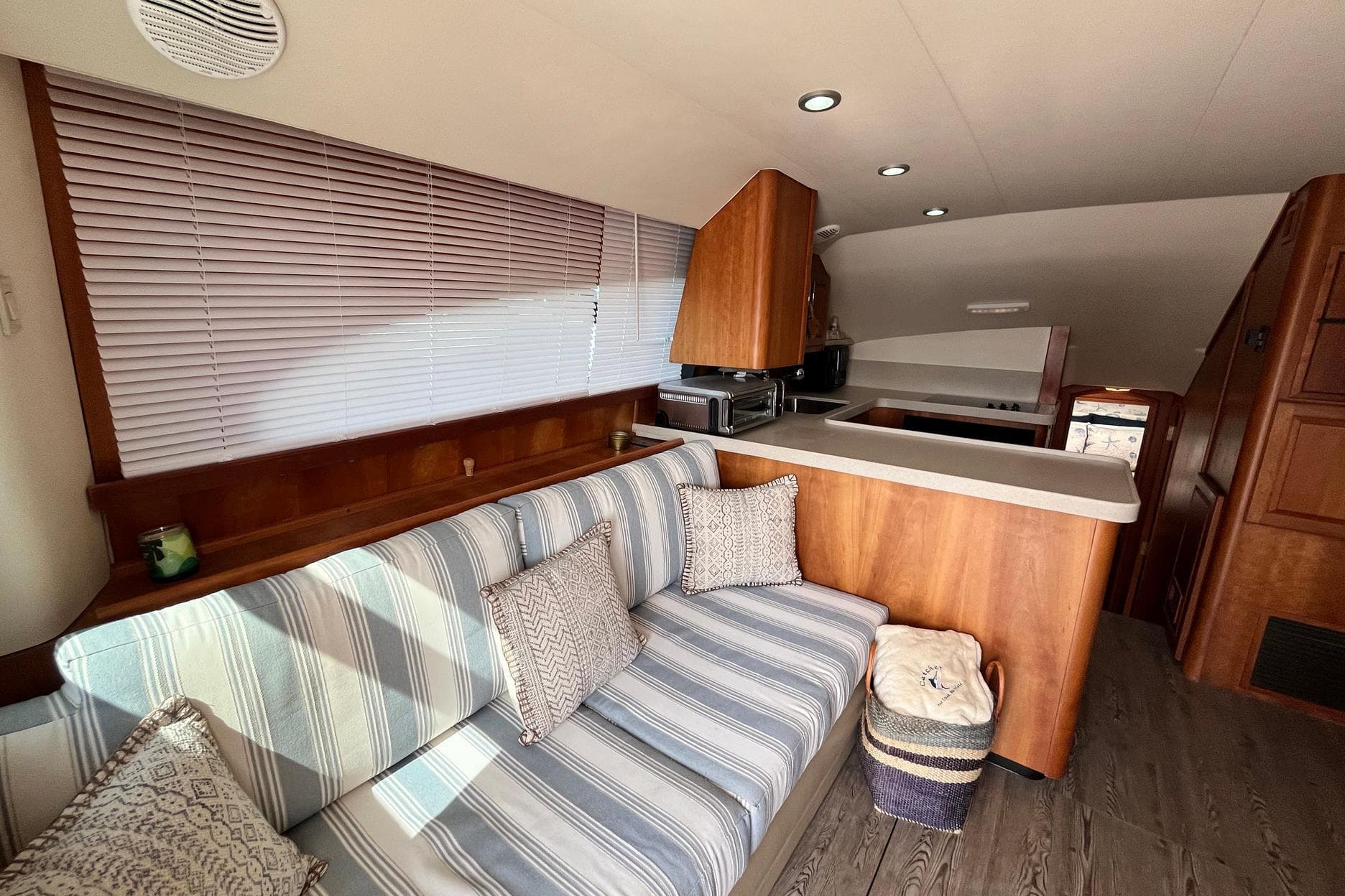 Interior of 2003 Luhrs 40 Convertible yacht with cozy seating and modern kitchen.