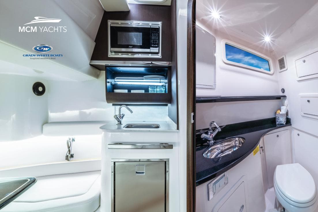 Luxurious interior of 2025 Grady-White Canyon 386 yacht with modern kitchen and bathroom amenities.
