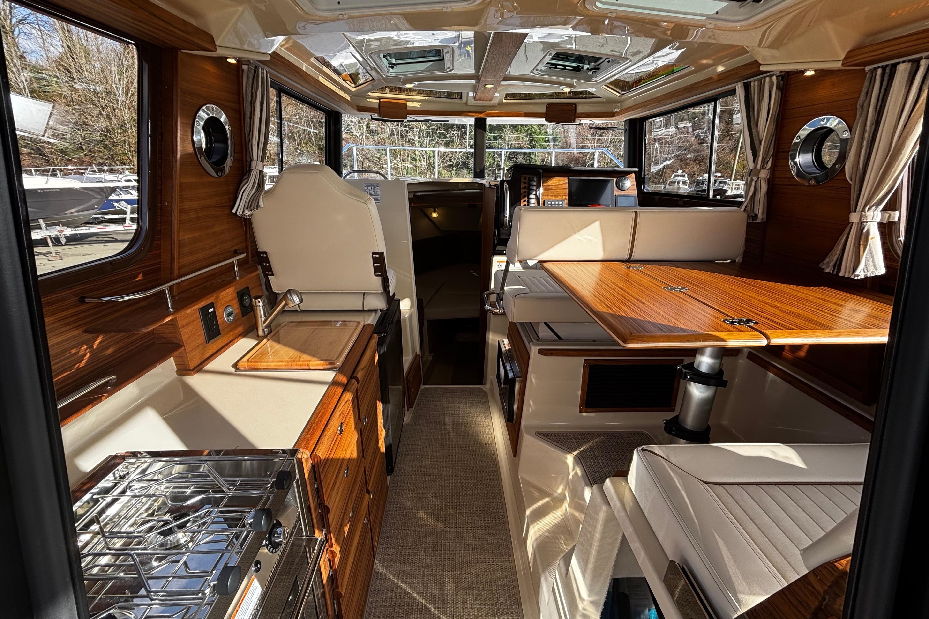 Interior of 2026 Ranger Tugs R-27 yacht with elegant wood finish.