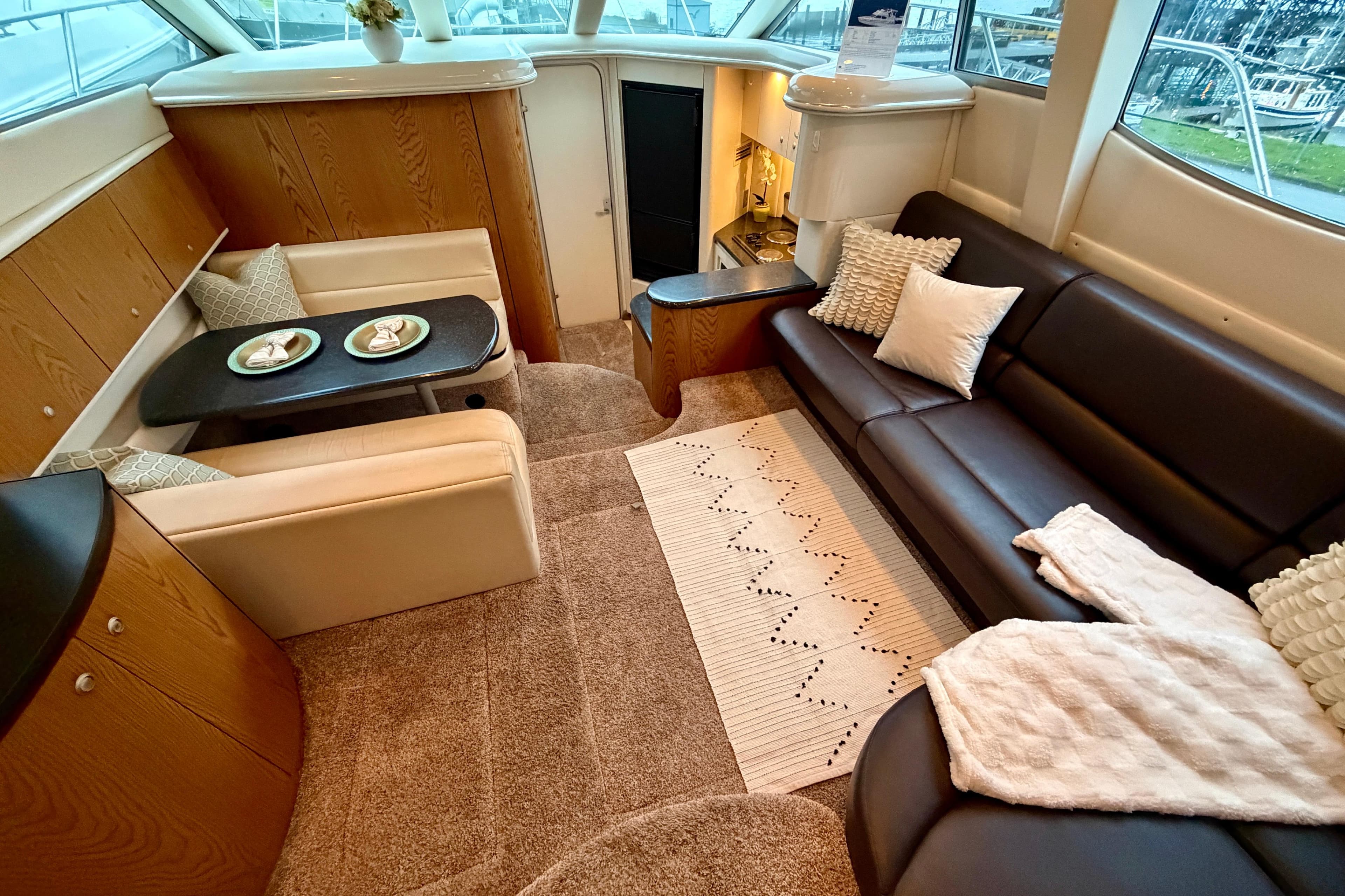 Luxurious interior of 2001 Maxum 4100 SCA yacht with cozy seating and elegant decor.
