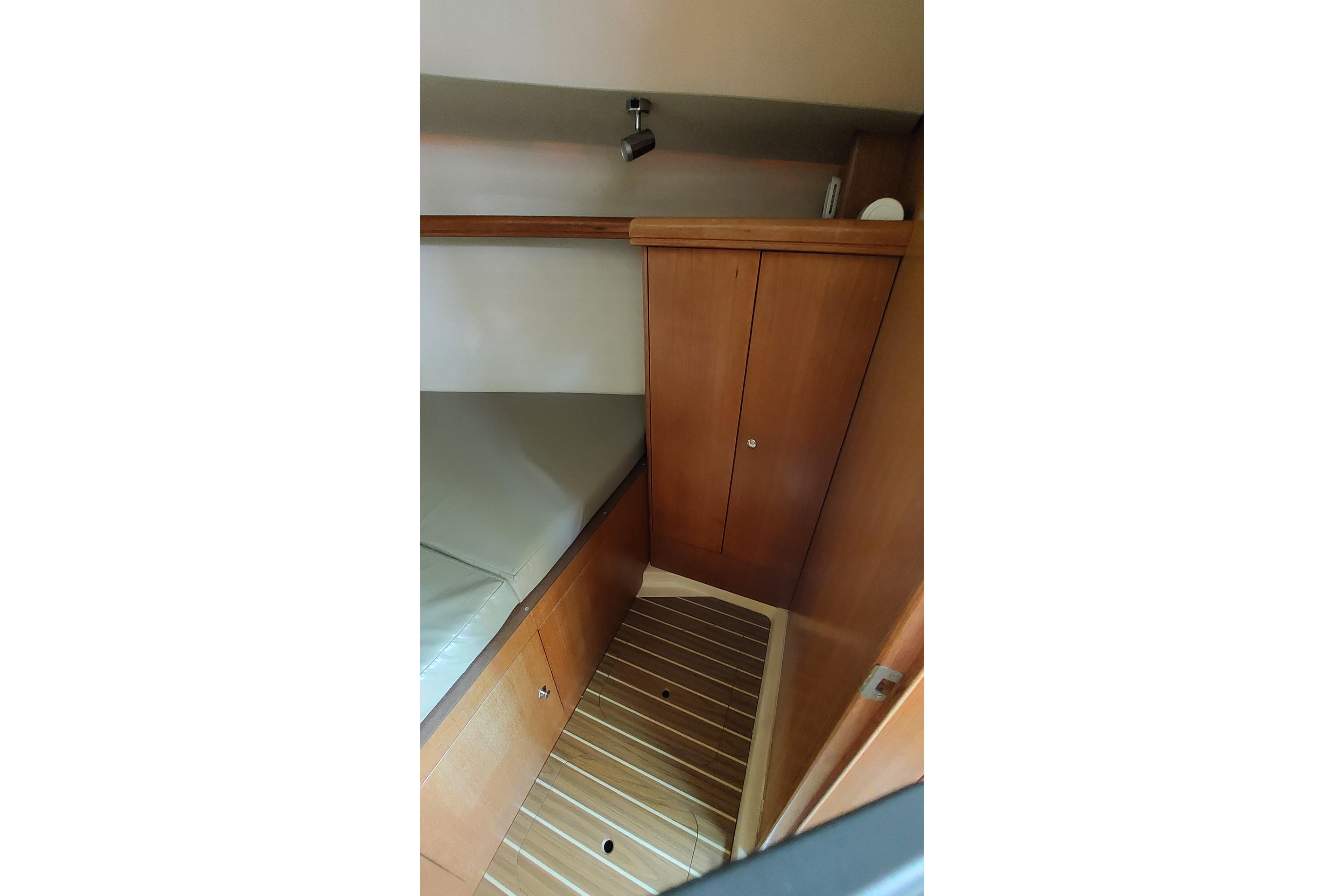 Interior cabin of 2005 Hunter 38 sailboat with wooden cabinetry and flooring.
