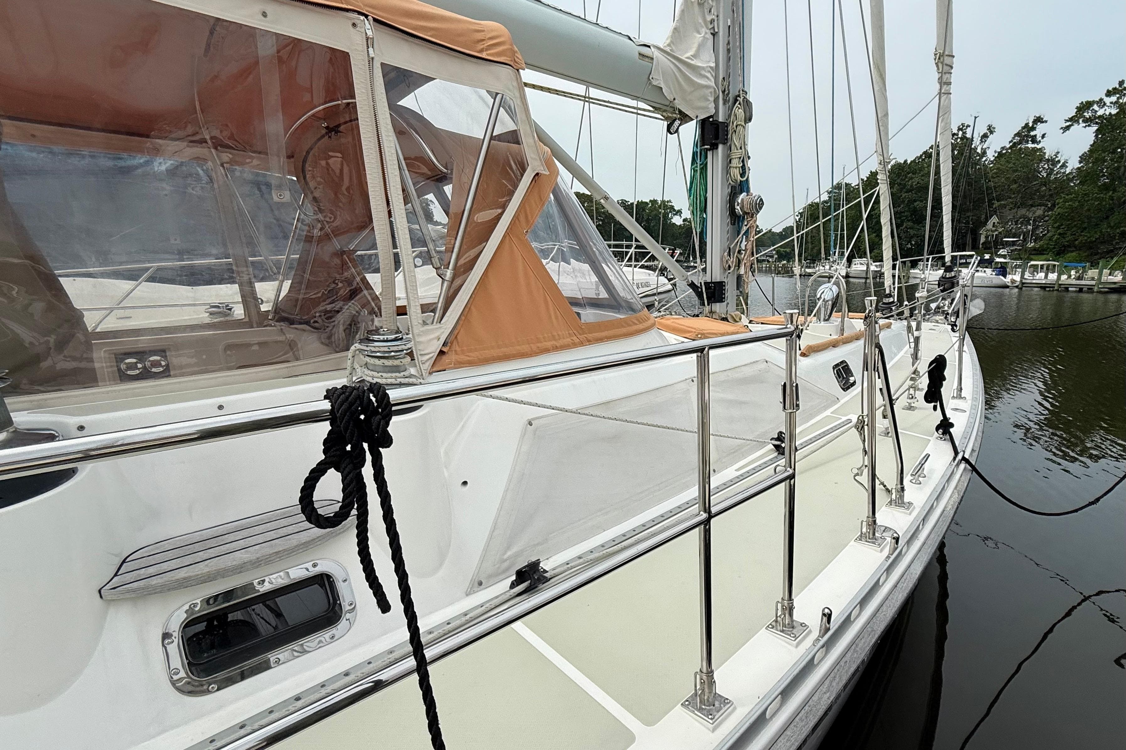 2008 Hylas 46 sailboat docked, featuring sleek design and orange canopy.