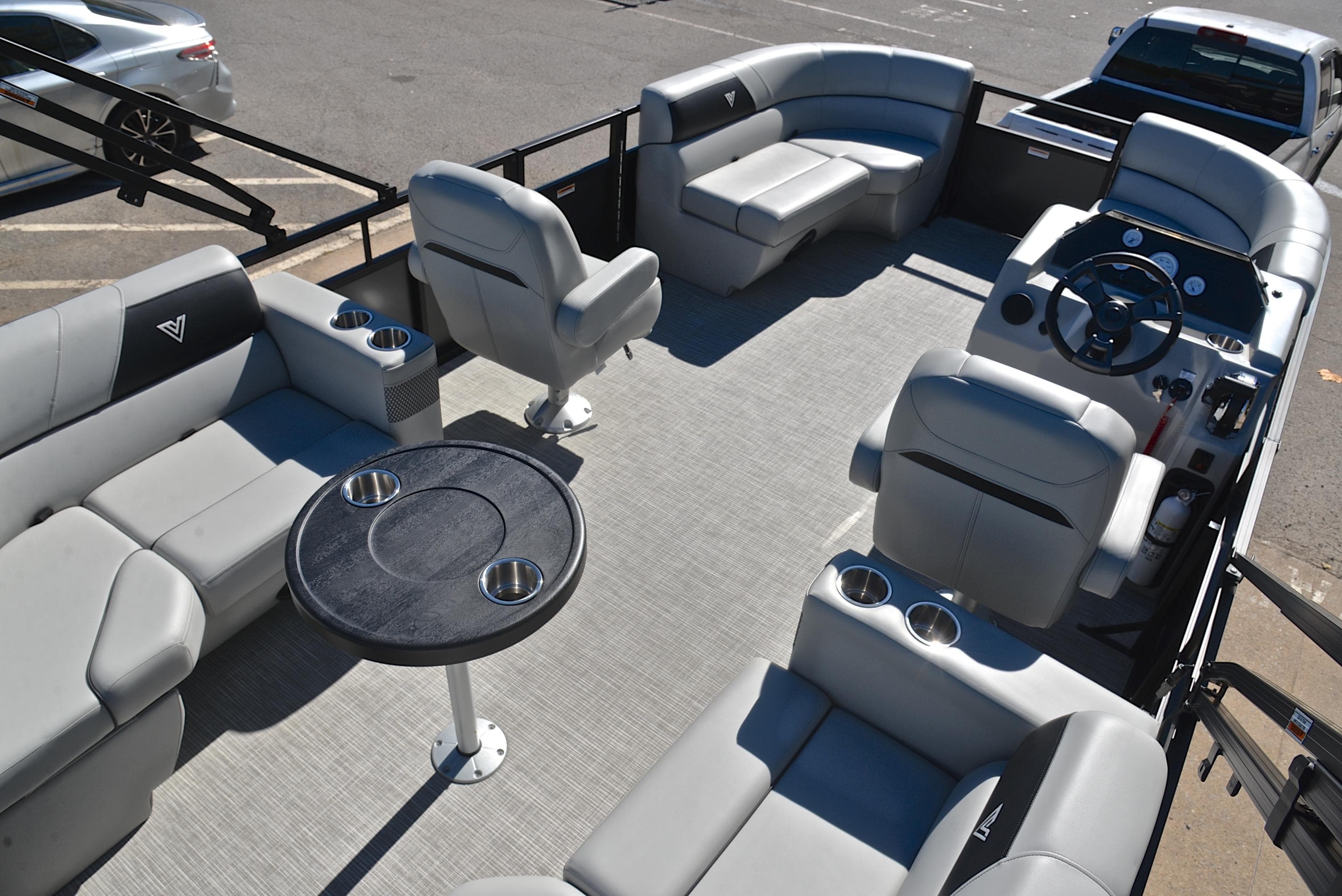 2023 Viaggio DM18U pontoon boat interior with gray seating and round table.