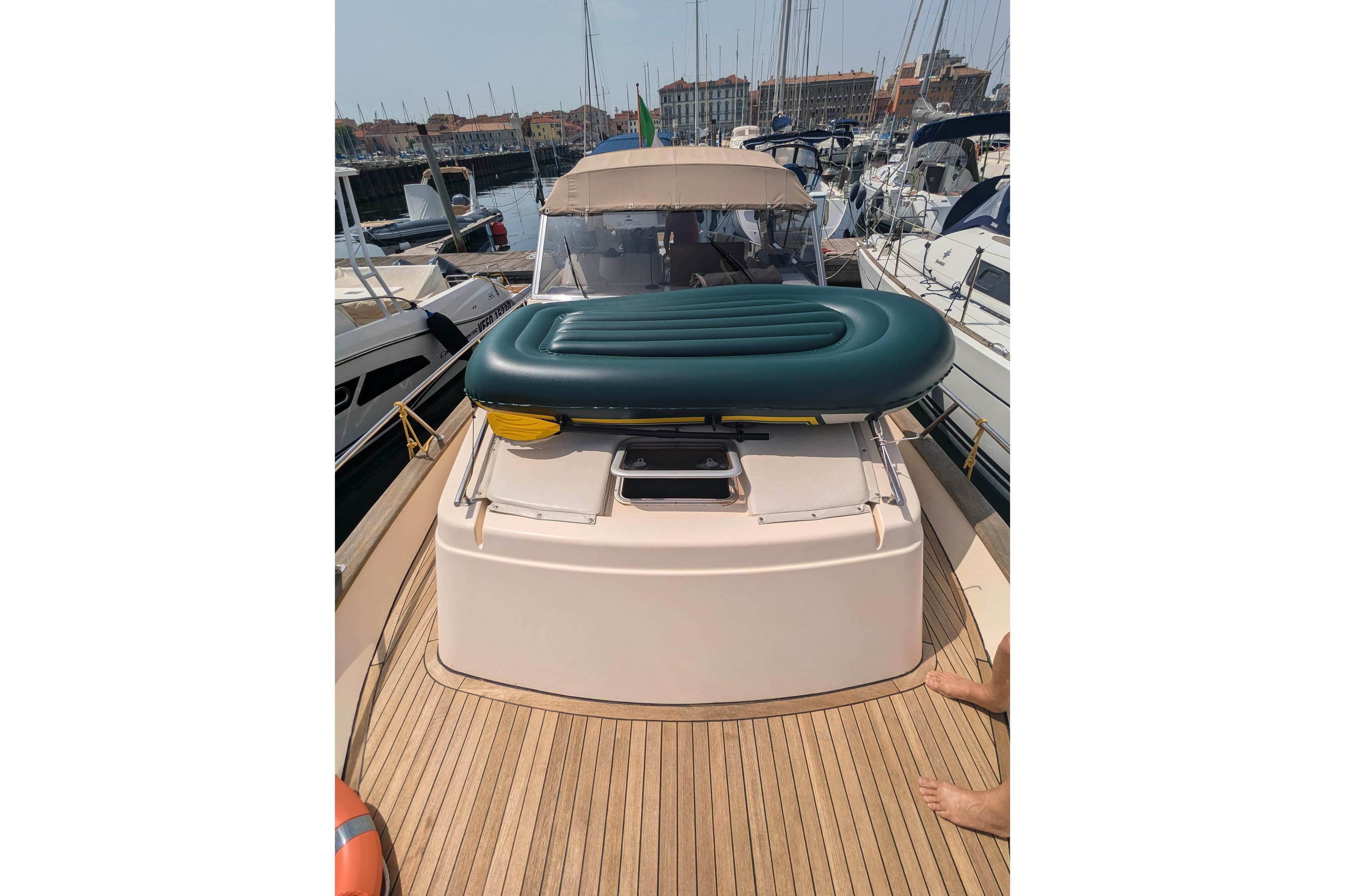 2001 Apreamare Smeraldo 9 yacht with inflatable mattress on deck, docked in marina.
