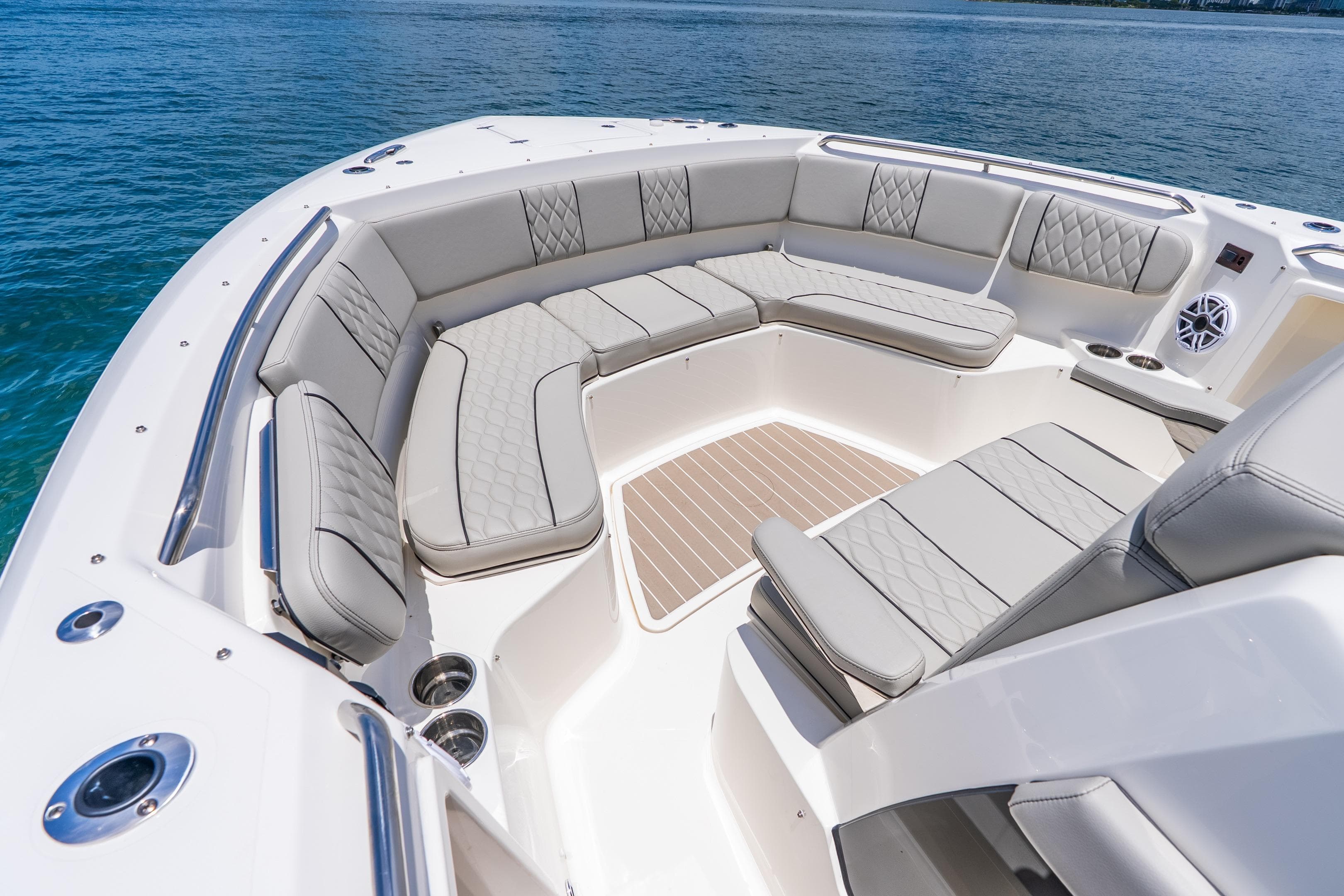 Luxurious seating area on 2026 Pursuit S 358 Sport boat, featuring elegant upholstery and ocean backdrop.