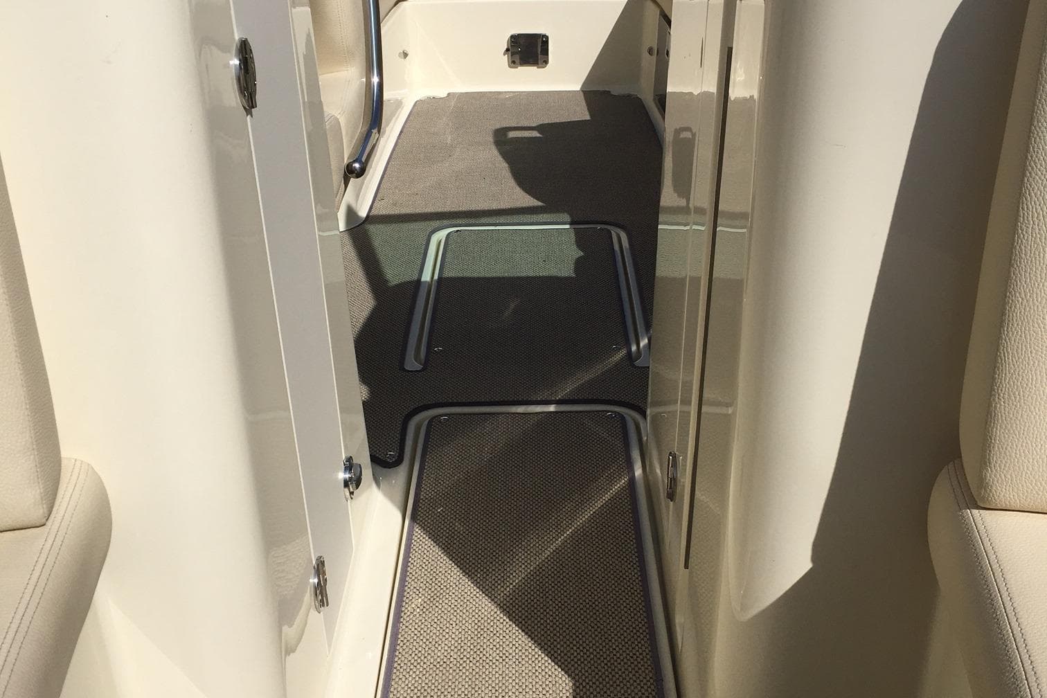 2019 Chris-Craft Launch 27 interior walkway with carpeted flooring.