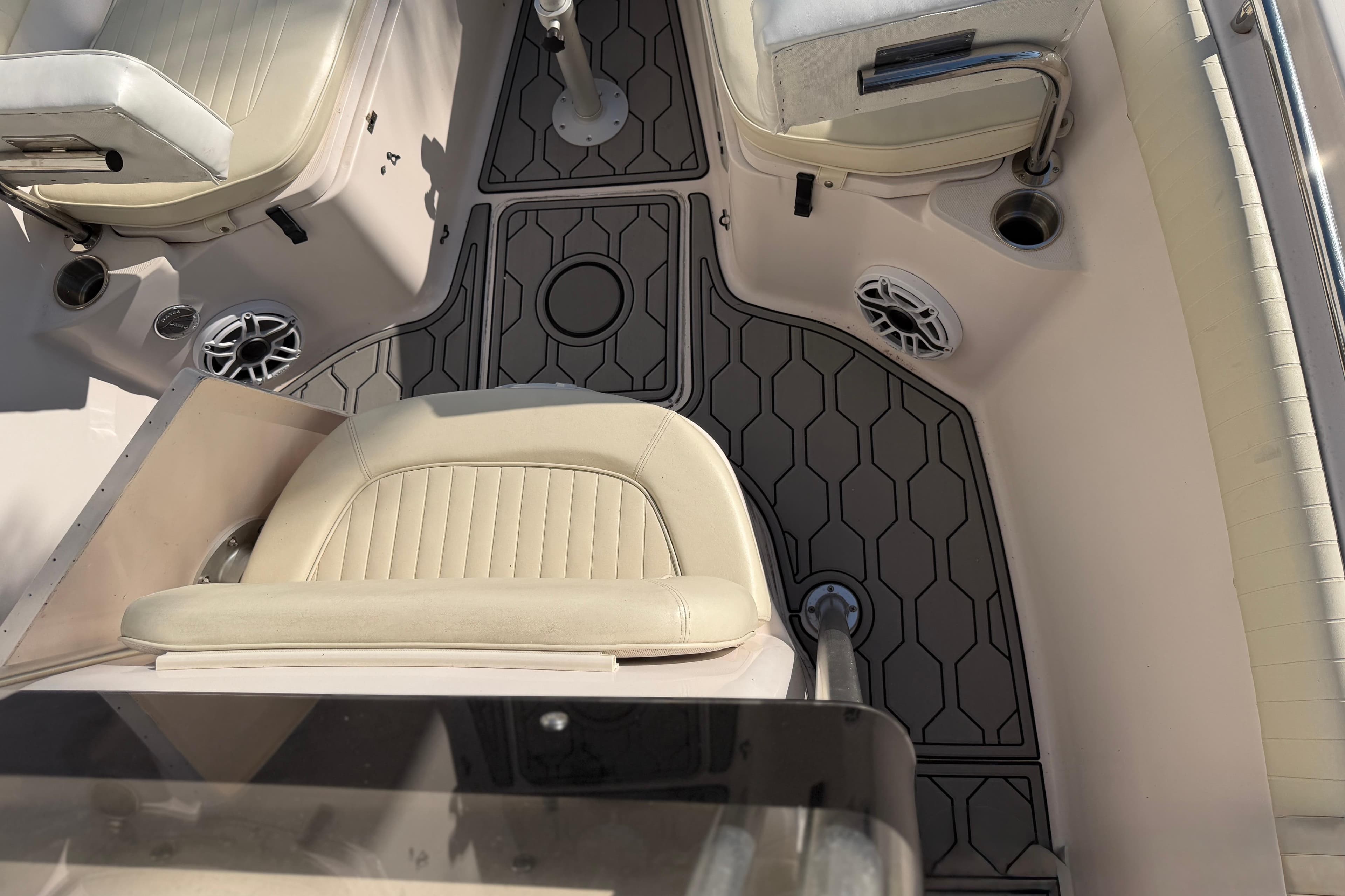 2004 Grady White 273 boat interior with cushioned seats and hexagonal floor design.