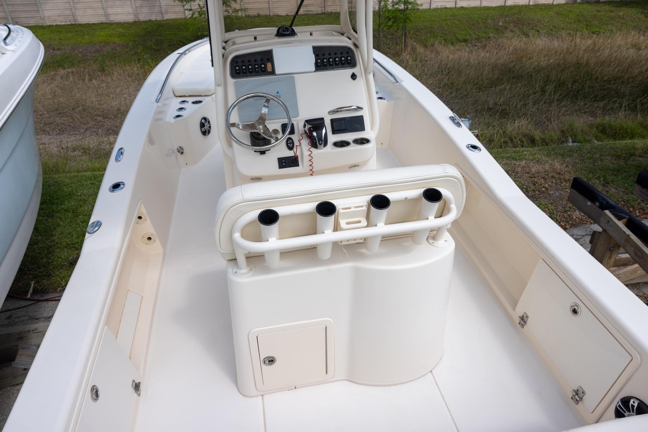 2021 Grady-White 251 Coastal Explorer boat interior with steering console and rod holders.