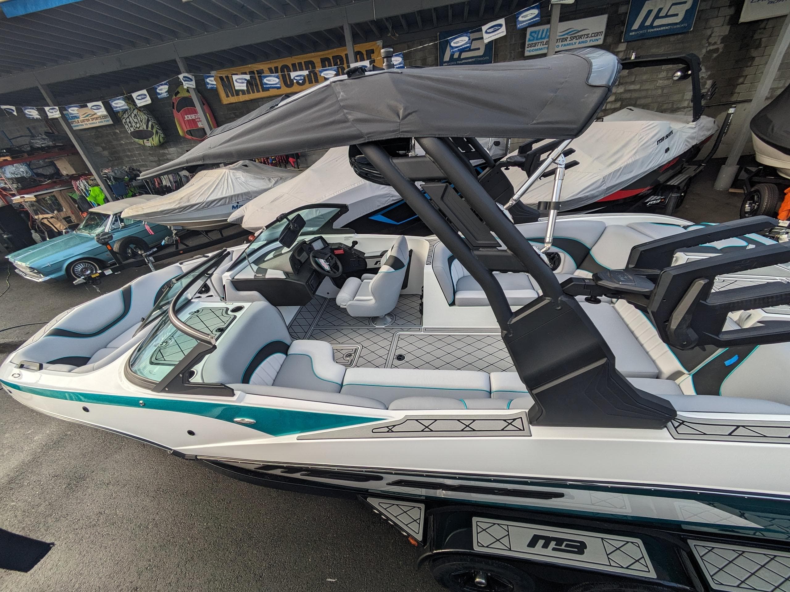 2025 MB B52-23 Alpha boat with sleek design and modern features, parked in showroom.