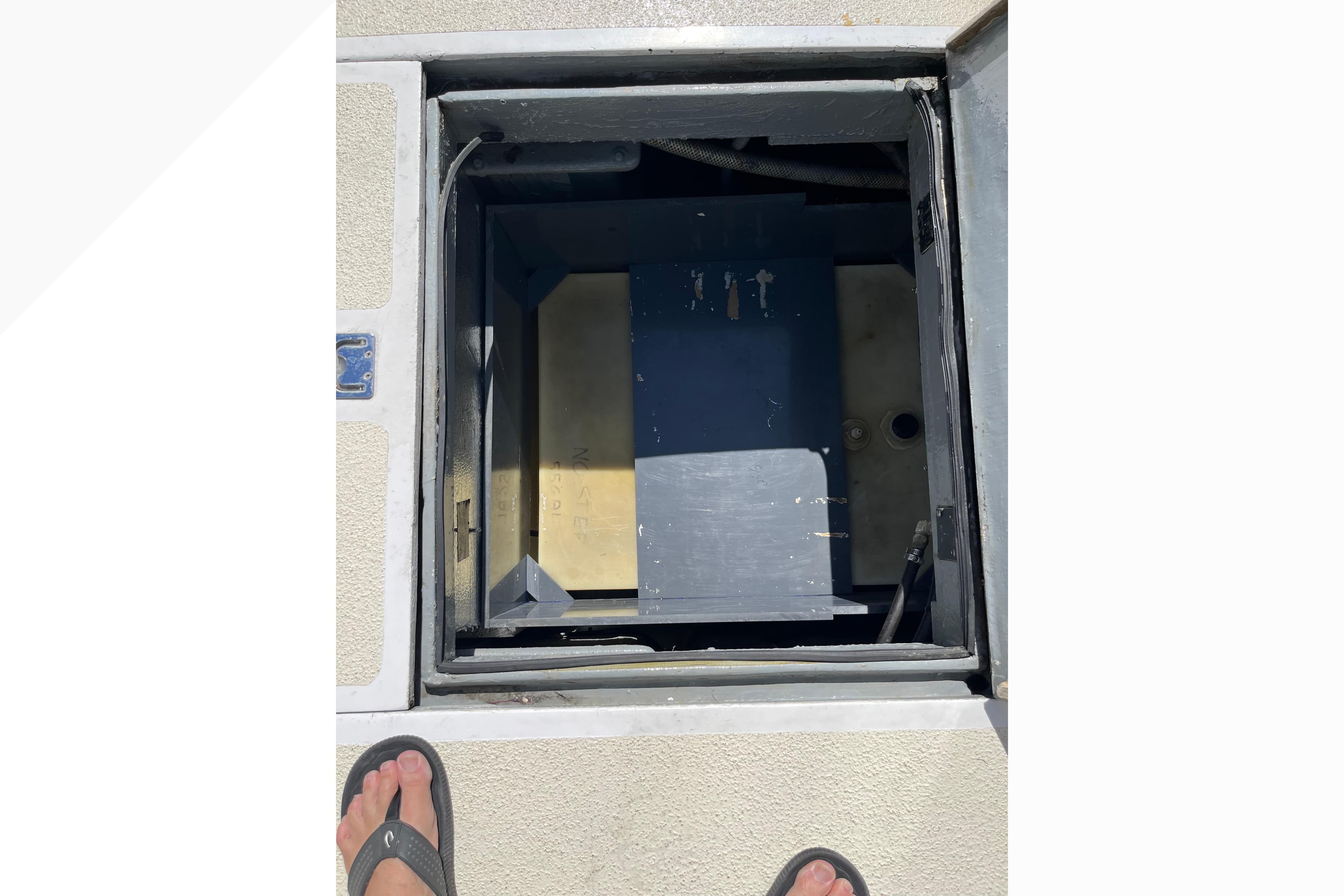 Open hatch on 1971 Pacifica 44 Convertible boat deck, revealing interior compartment.