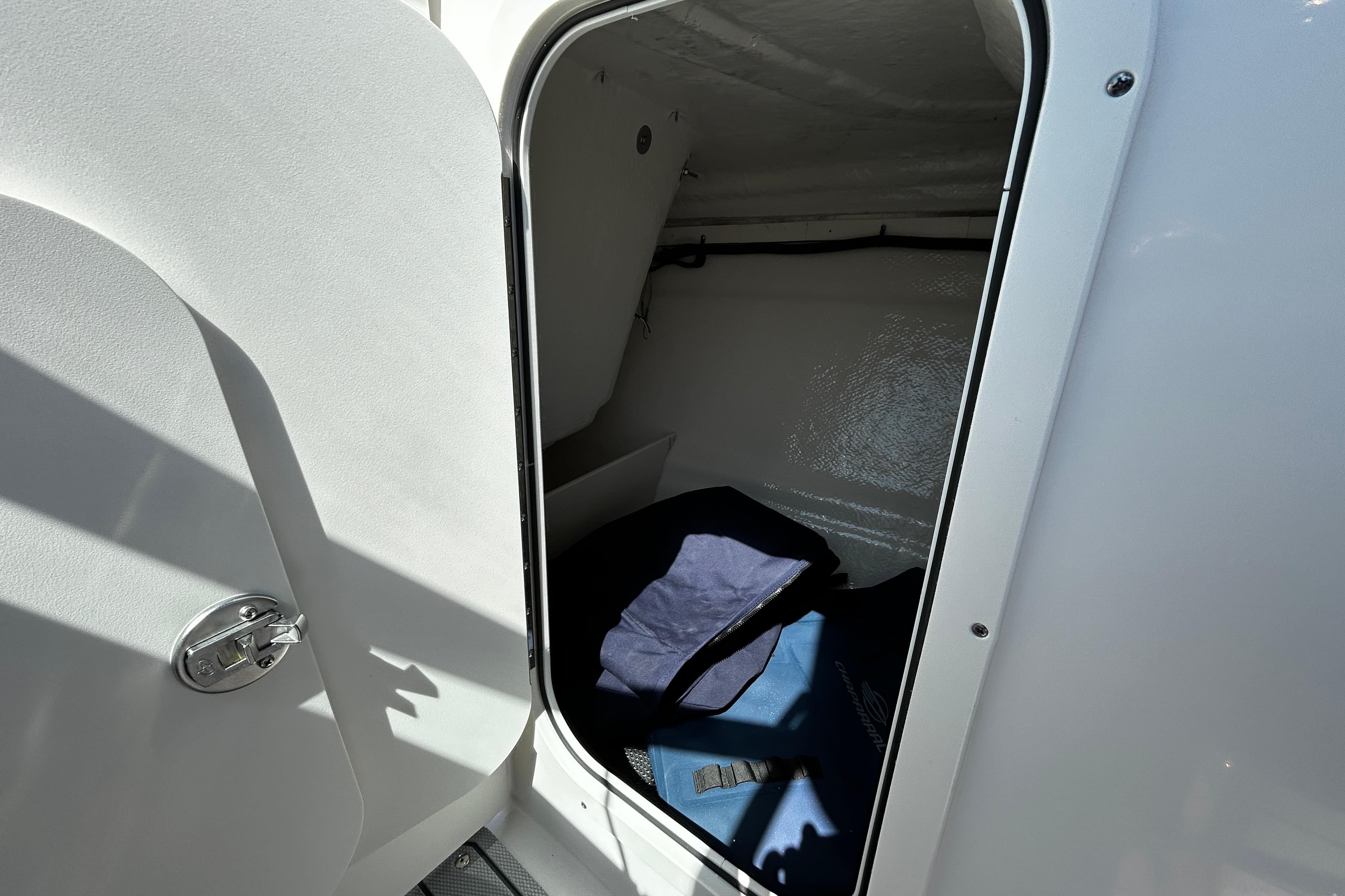 Interior cabin view of 2025 Chaparral 23 SSi OB boat, showcasing storage space.