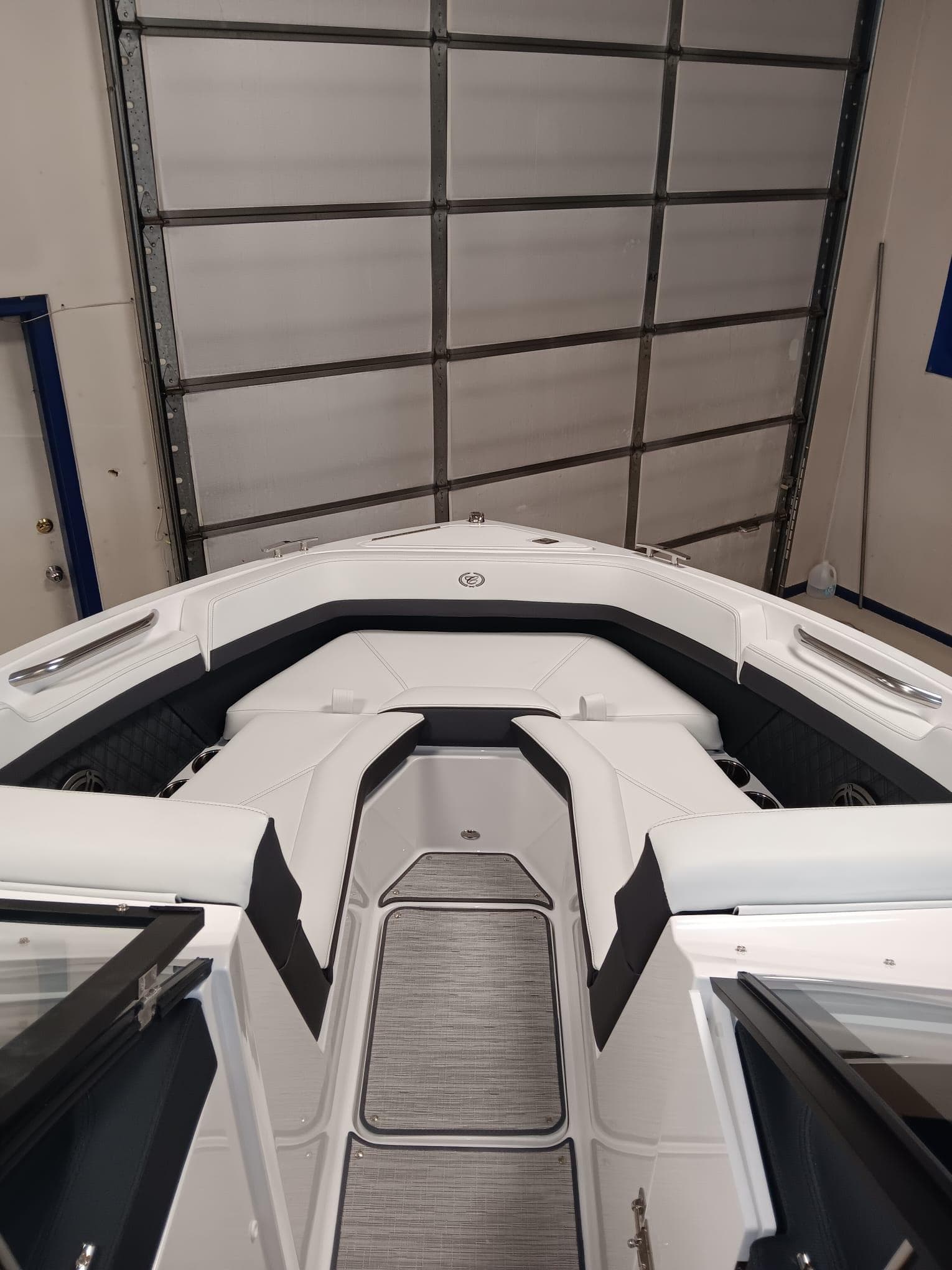 2026 Cobalt R4 boat interior with sleek white seating and modern design in a garage setting.