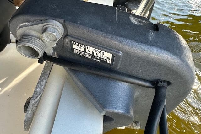 Yamaha LF150X8 engine part on 2018 NauticStar 2602 Legacy boat, docked by water.