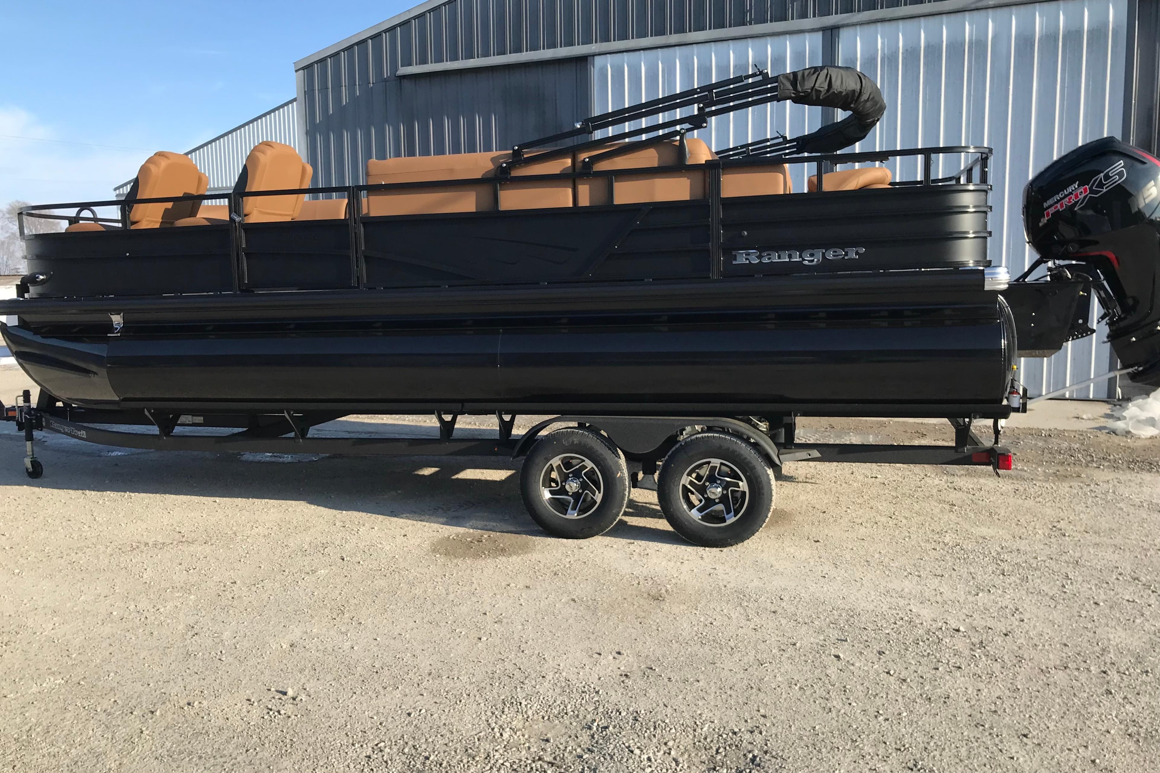 2026 Ranger Reata 220FC pontoon boat on trailer, black exterior, parked outdoors.