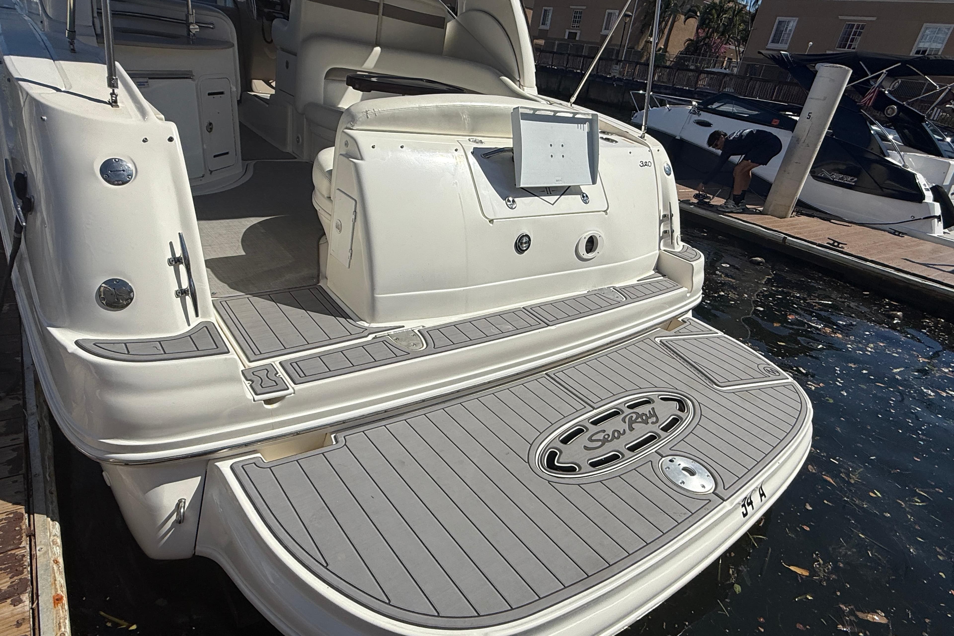 2003 Sea Ray 320 Sundancer yacht docked, showcasing spacious rear deck and elegant design.