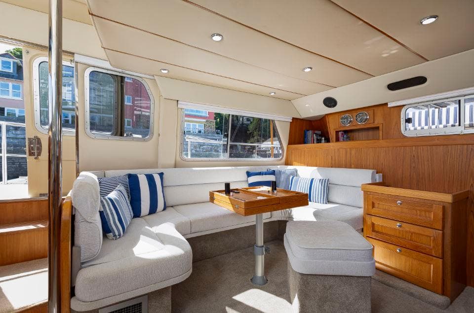 Interior of 2002 Hardy Commodore 42 yacht with cozy seating and nautical decor.