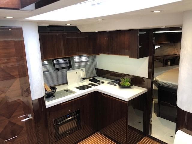 Luxurious kitchen interior of 2018 Galeon 485 yacht with modern amenities and sleek design.