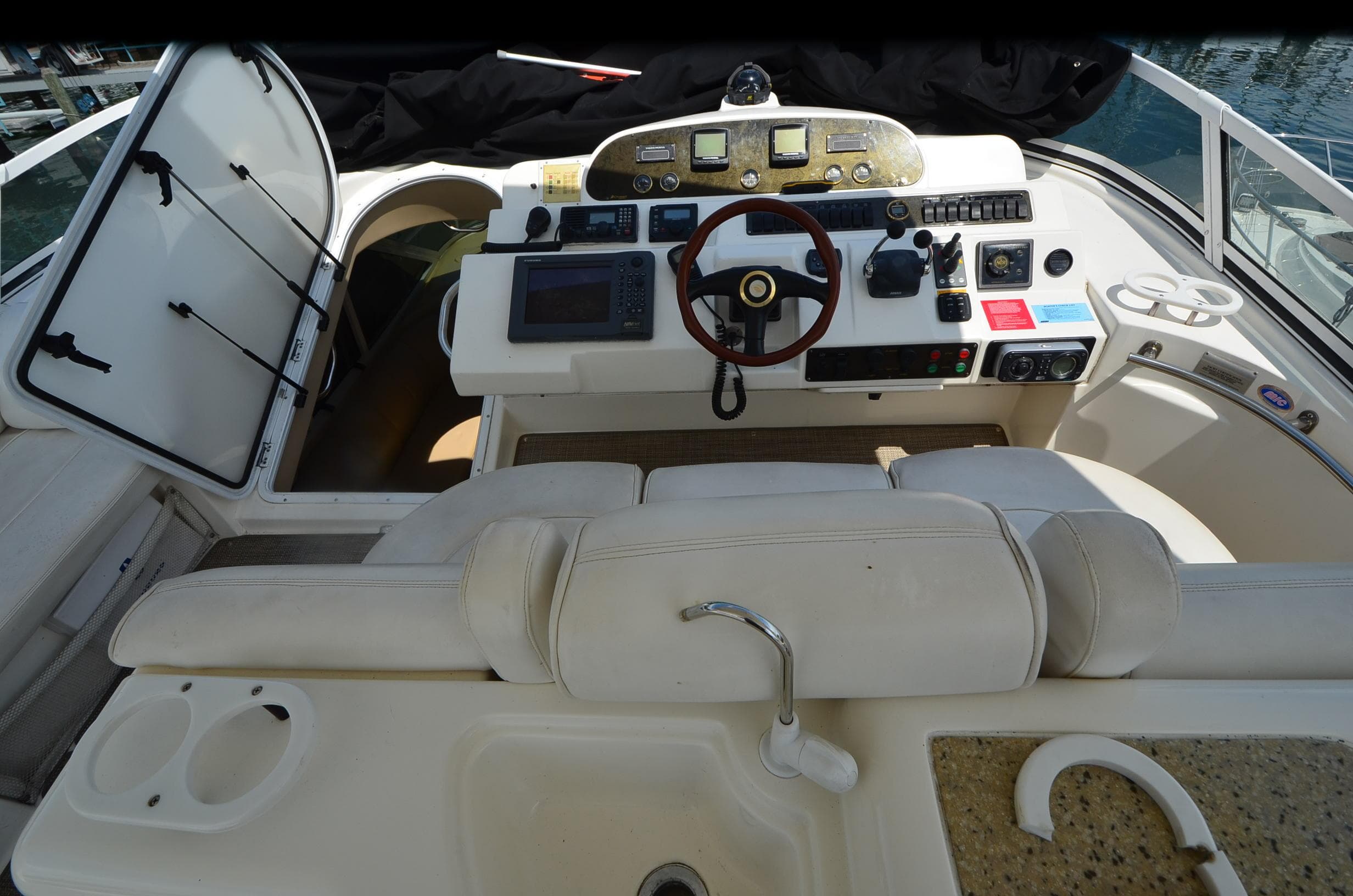 2003 Cruisers Yachts 5000 Sedan Sport helm with steering wheel and navigation controls.