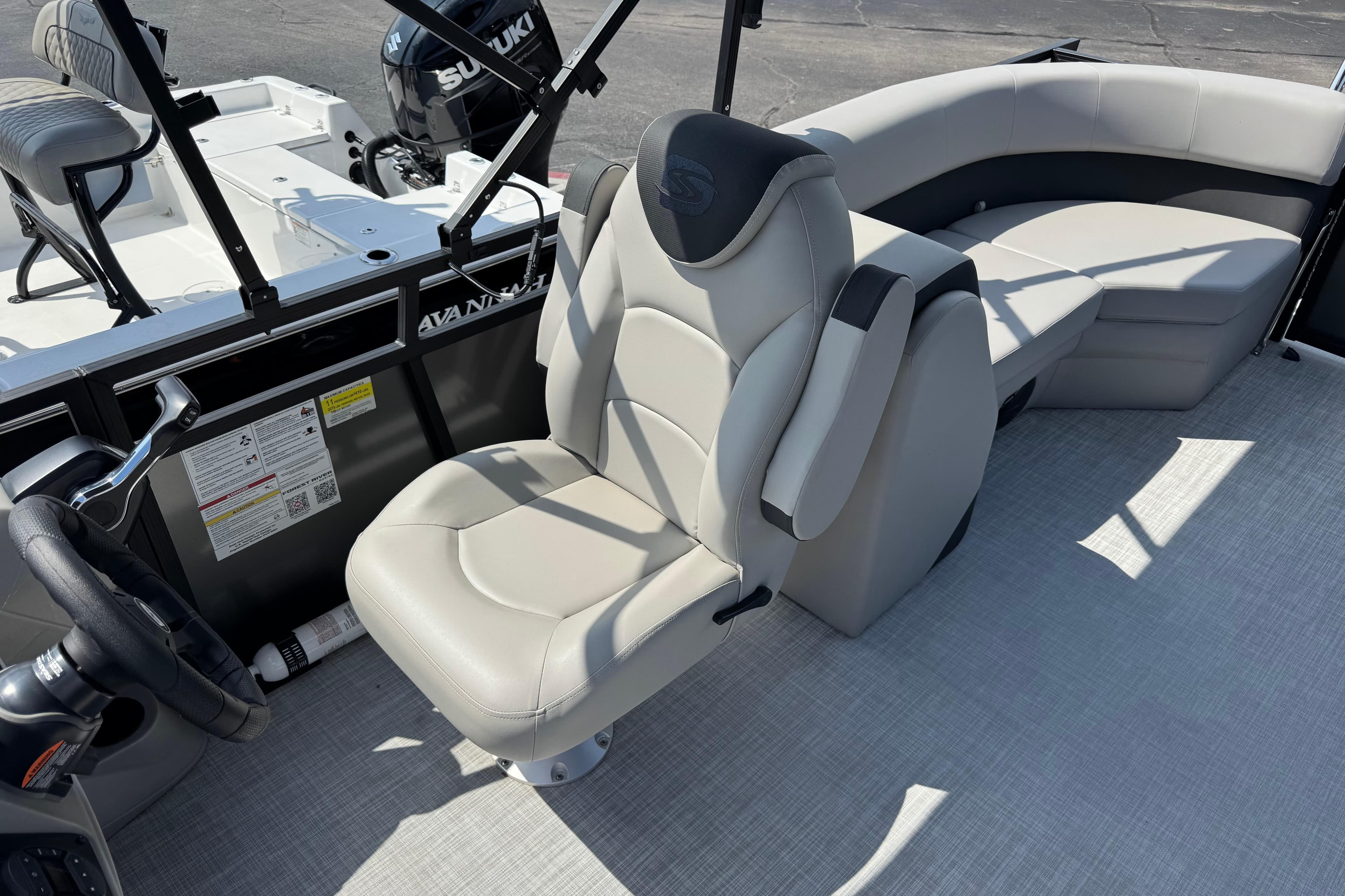 Interior of 2026 Dockside 22 DQ boat with modern seating and steering wheel.
