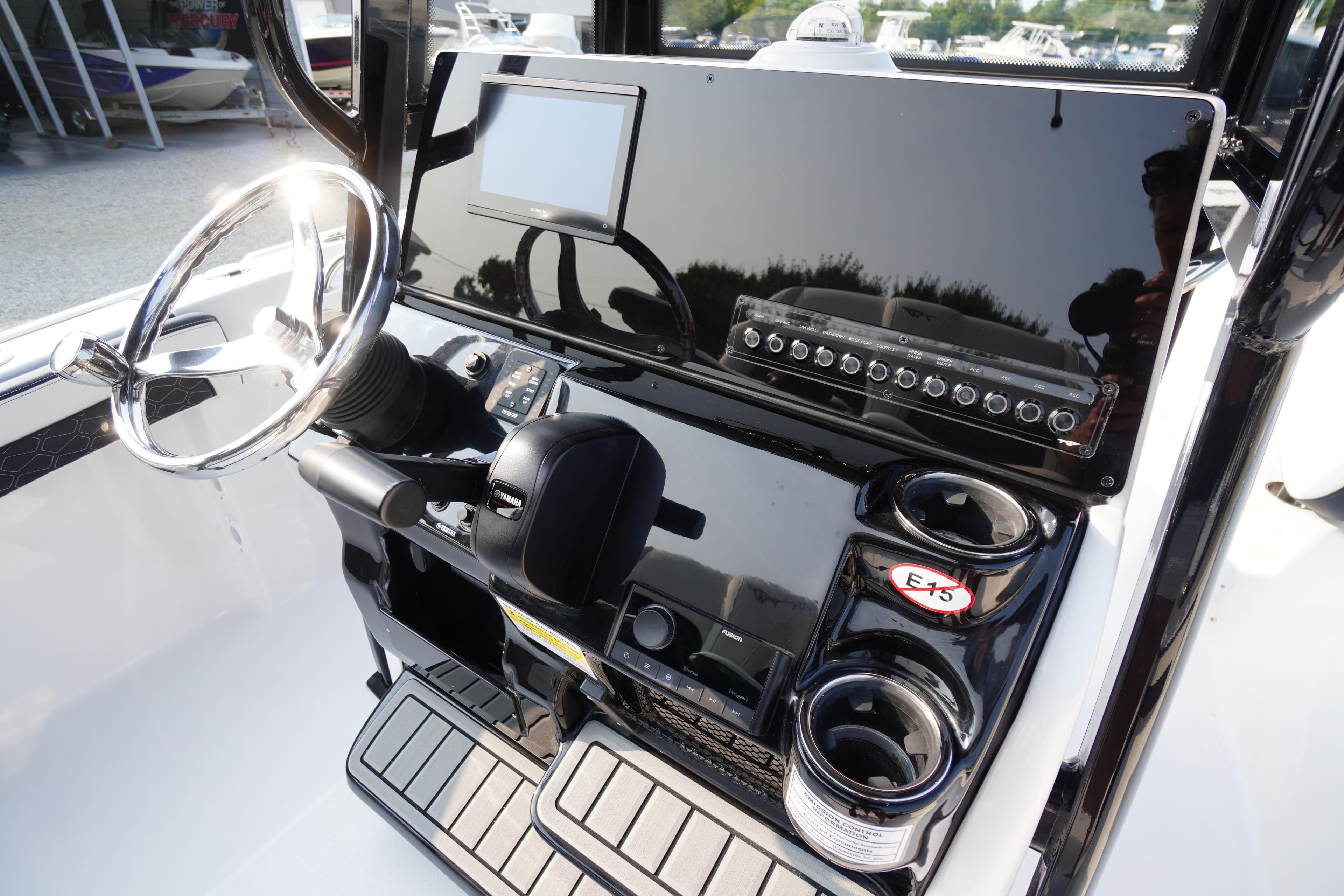 2026 Tidewater 210 LXF boat dashboard with steering wheel and control panel.