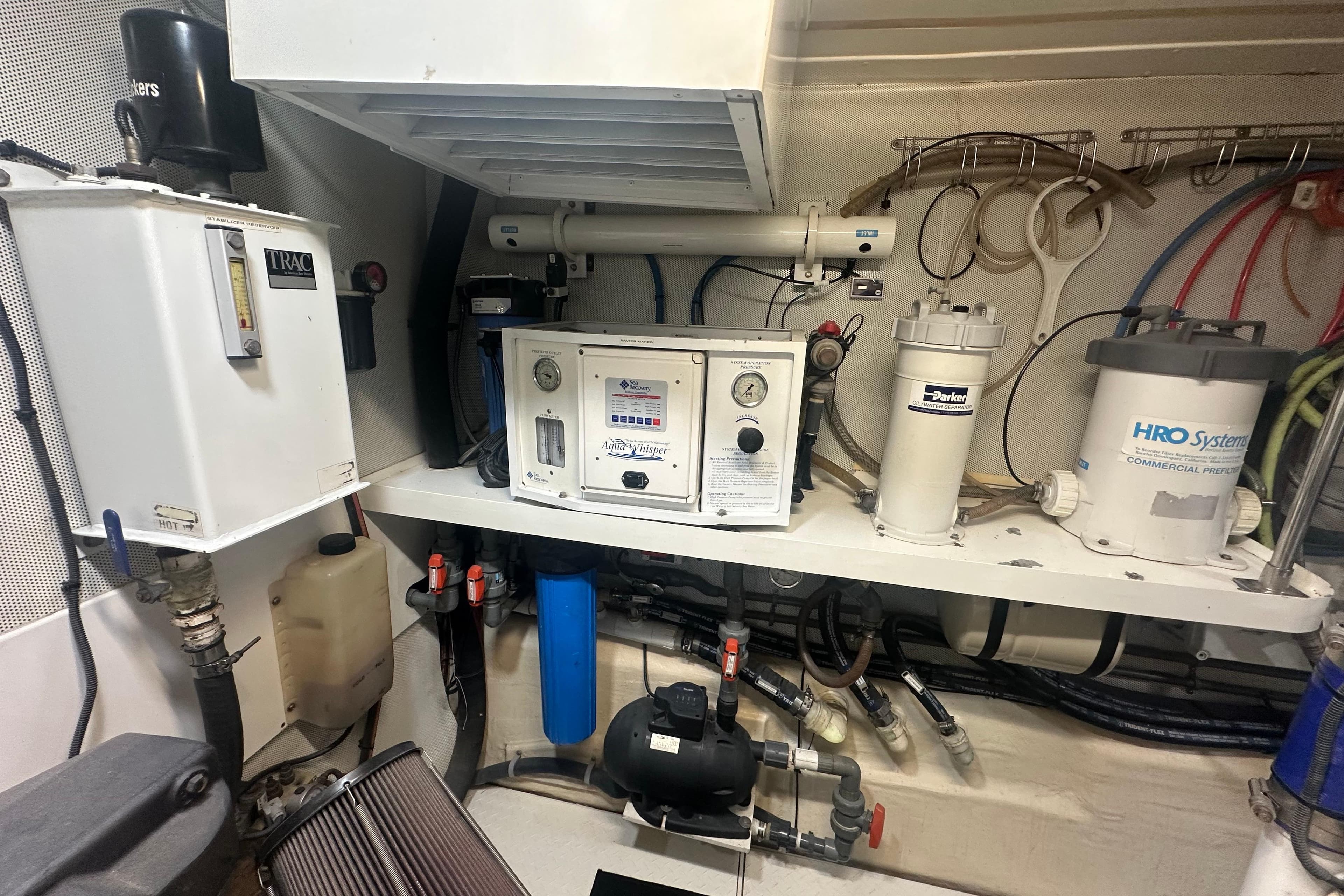 Engine room of a 2006 Lazzara 68 Motoryacht with water filtration systems.
