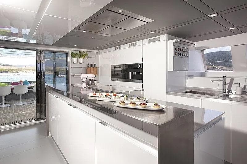 Luxurious Sunreef 70 yacht kitchen, 2013 model, featuring modern design and outdoor view.