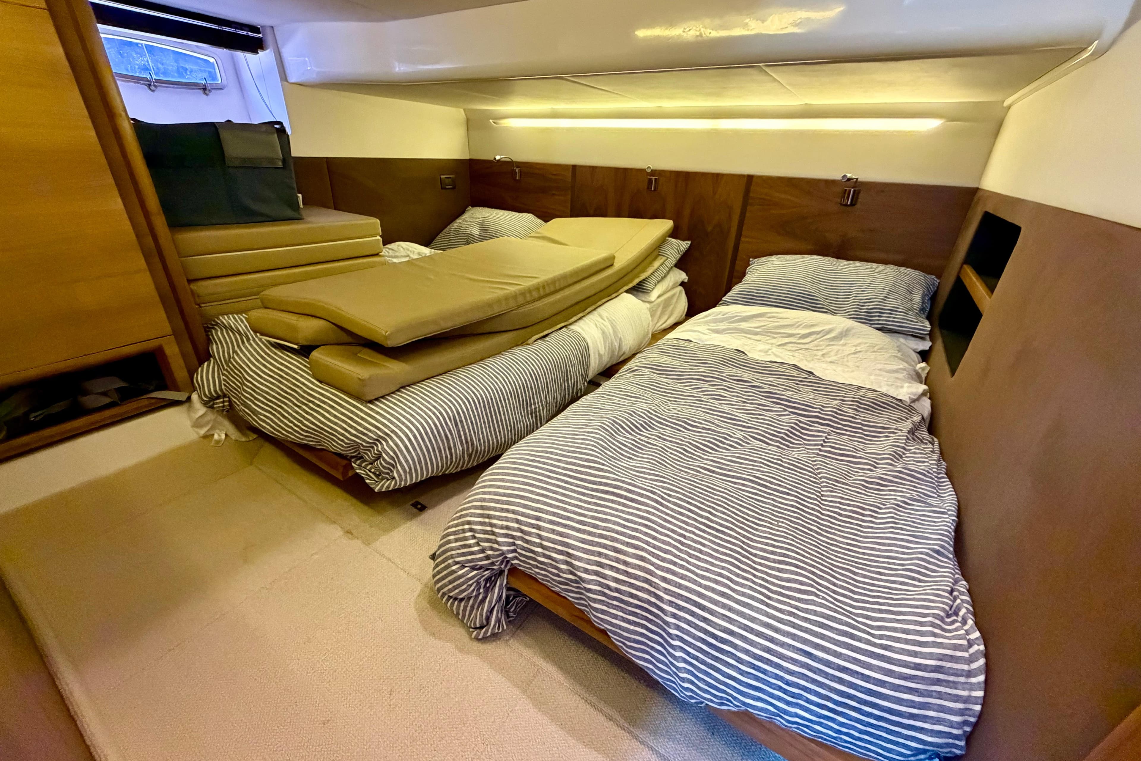 2012 Sealine SC42 cabin with twin beds, striped bedding, and wooden interior.