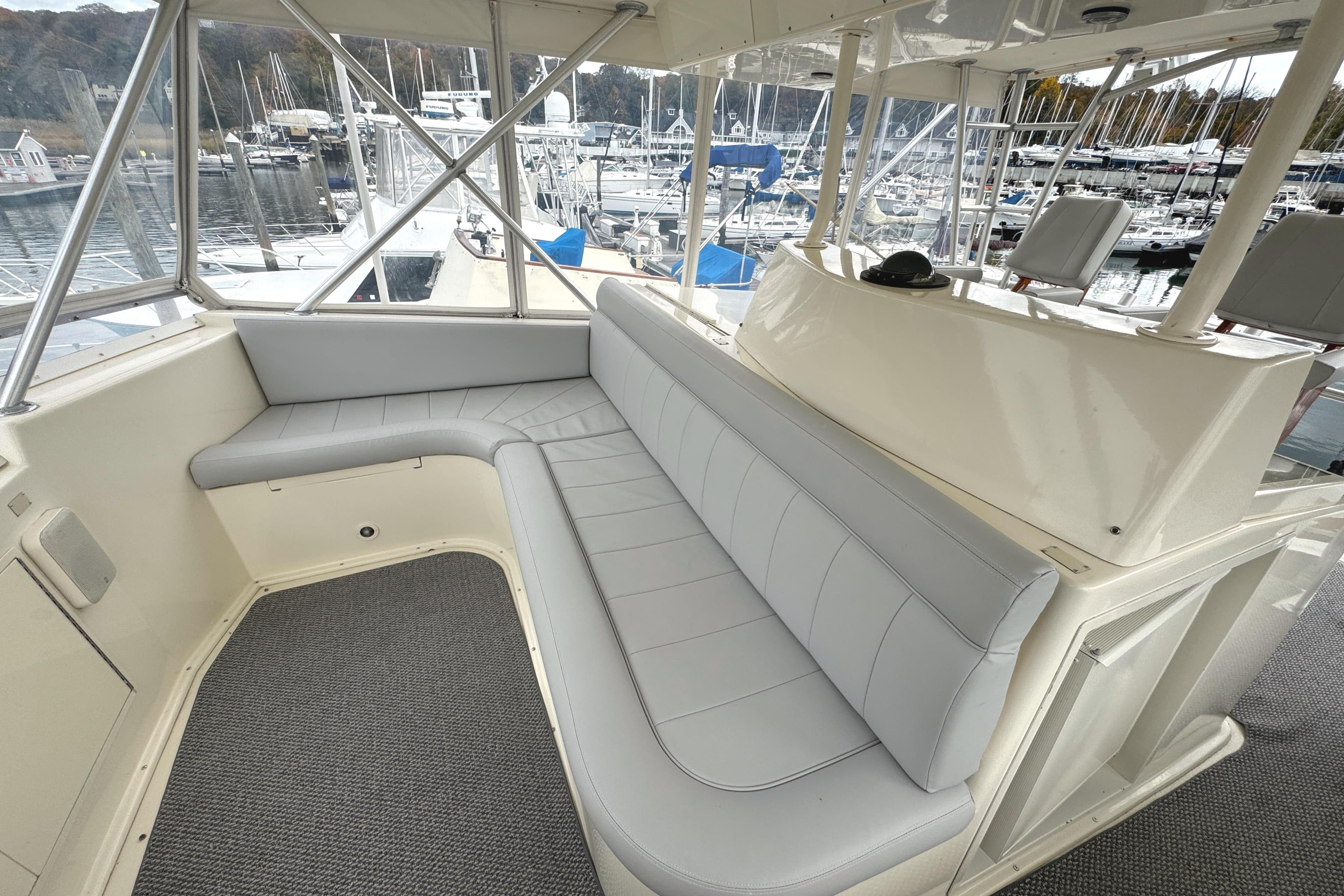 1991 Viking 53 Convertible yacht interior with gray seating and marina view.
