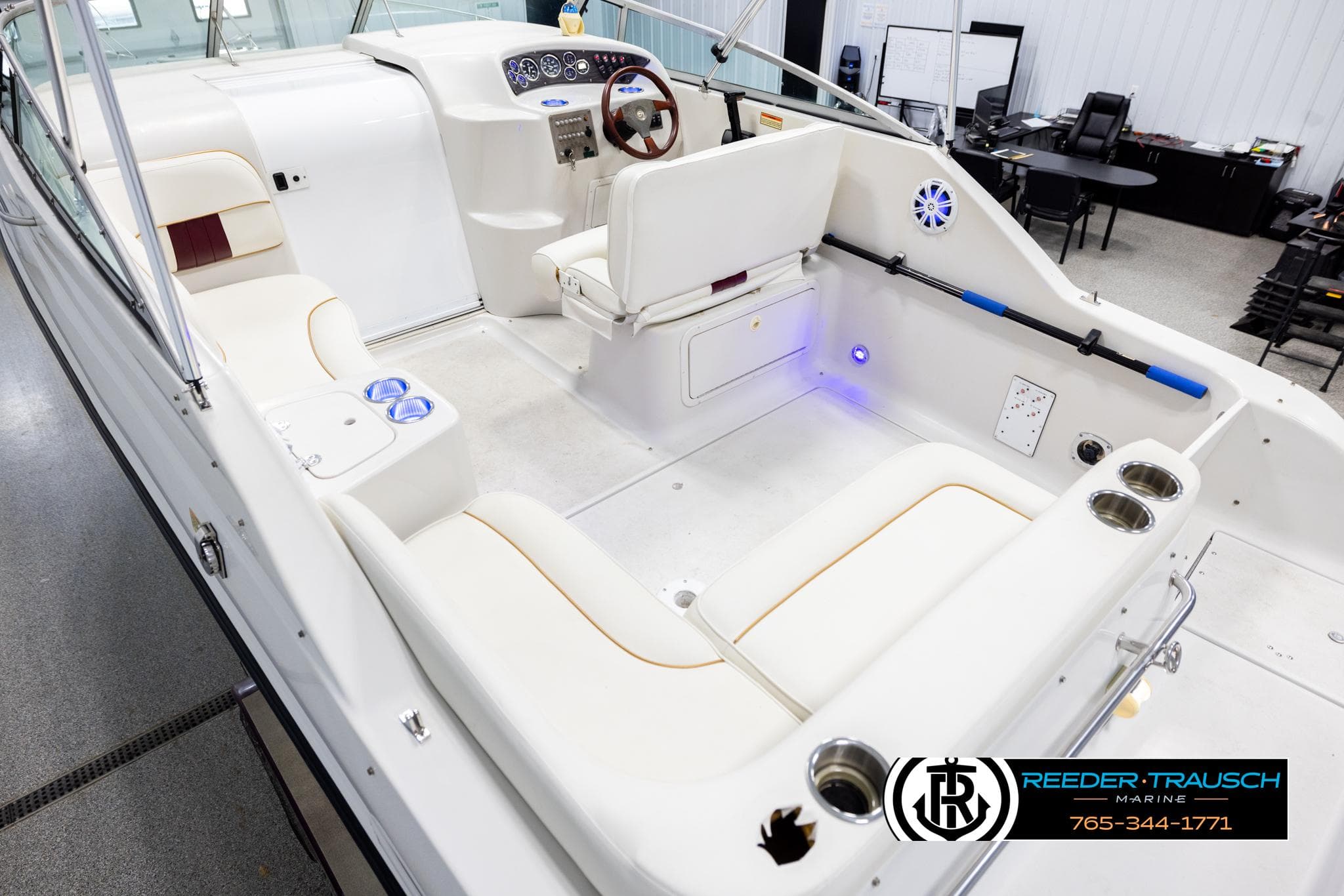 1999 Crownline 242 CR boat interior with white seating and modern dashboard.
