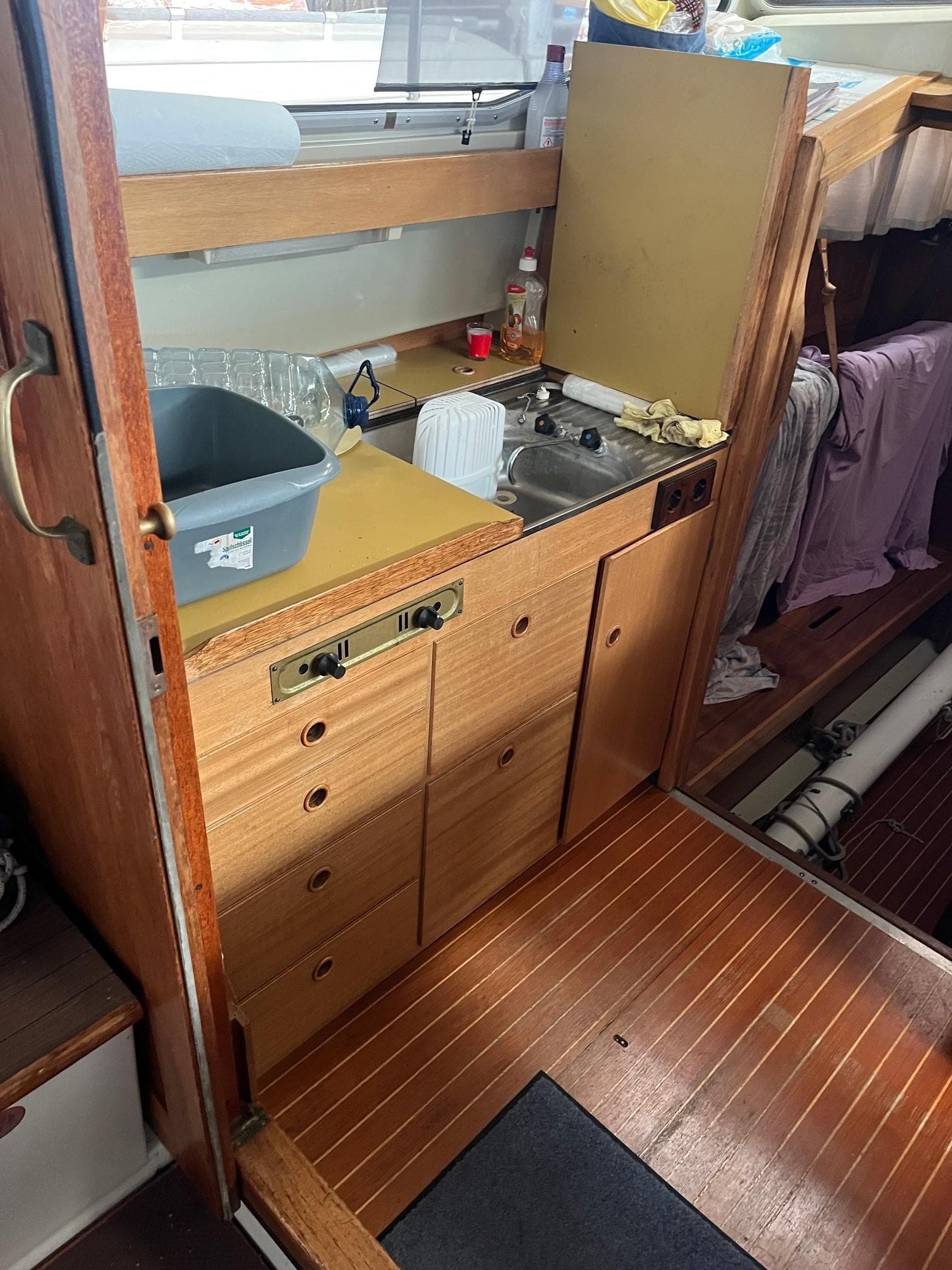 Small wooden boat kitchen with sink, storage, and countertop, LM 32 model, 1980.