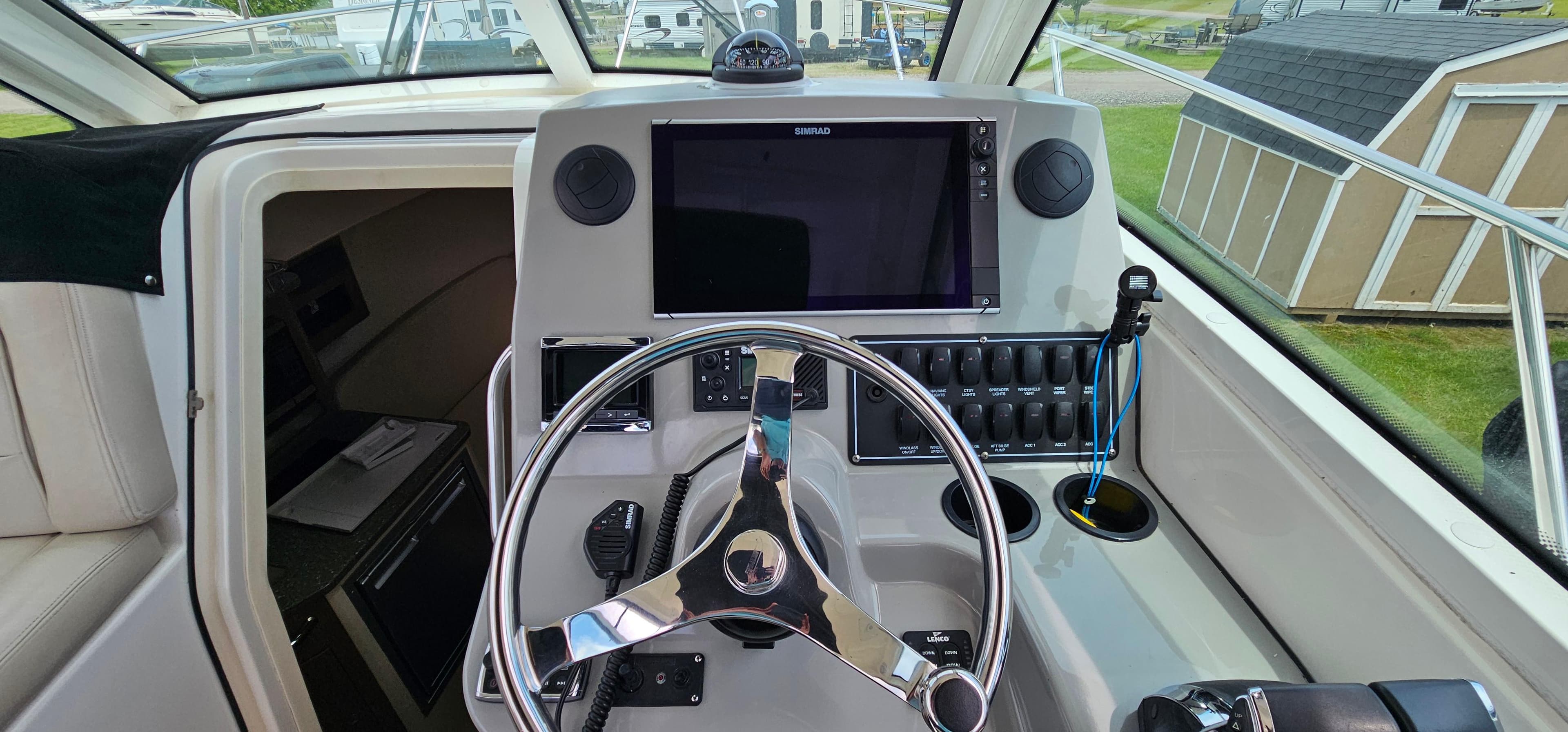 2016 Boston Whaler 285 Conquest helm with steering wheel and navigation display.