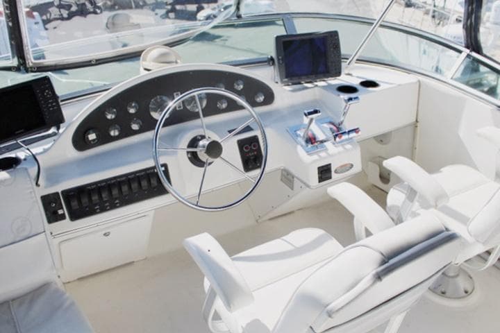 1997 Bayliner 4087 Aft Cabin Motoryacht helm with dual seats and navigation equipment.