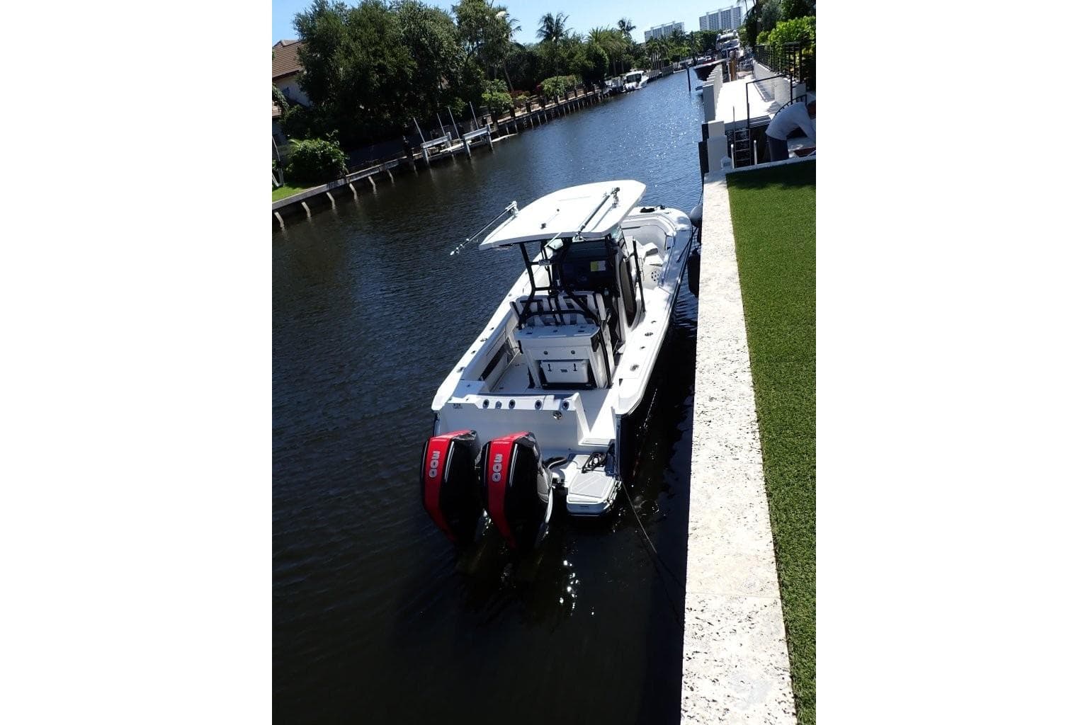 2022 Blackfin 272 CC boat docked in a serene canal setting.