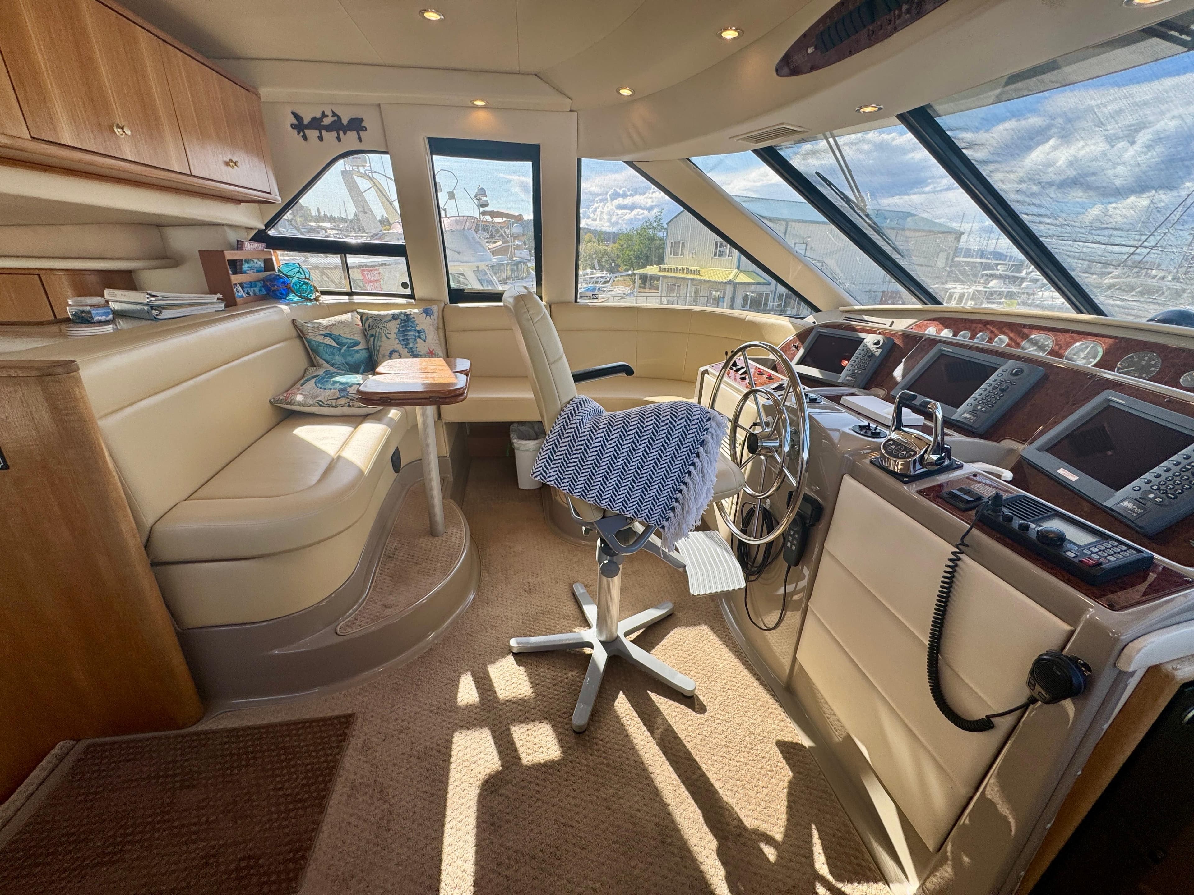 1999 Bayliner 5288 Pilot House Motoryacht interior with helm, seating, and navigation equipment.