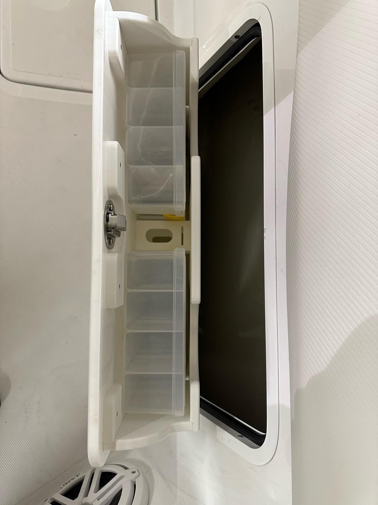 2021 Wellcraft 262 Fisherman tackle storage compartment with organized slots.
