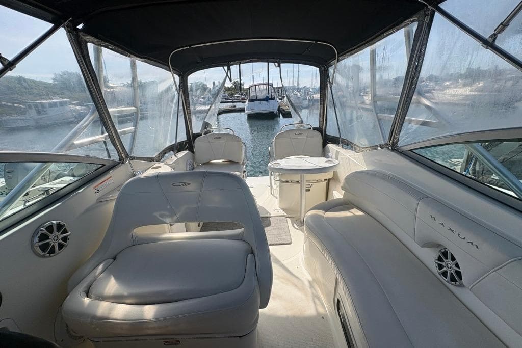 2008 Maxum 2700 SE boat interior with seating and table, docked at marina.