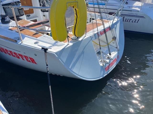 Beneteau First 36.7 sailboat, 2007 model, docked with visible life preserver and water reflections.