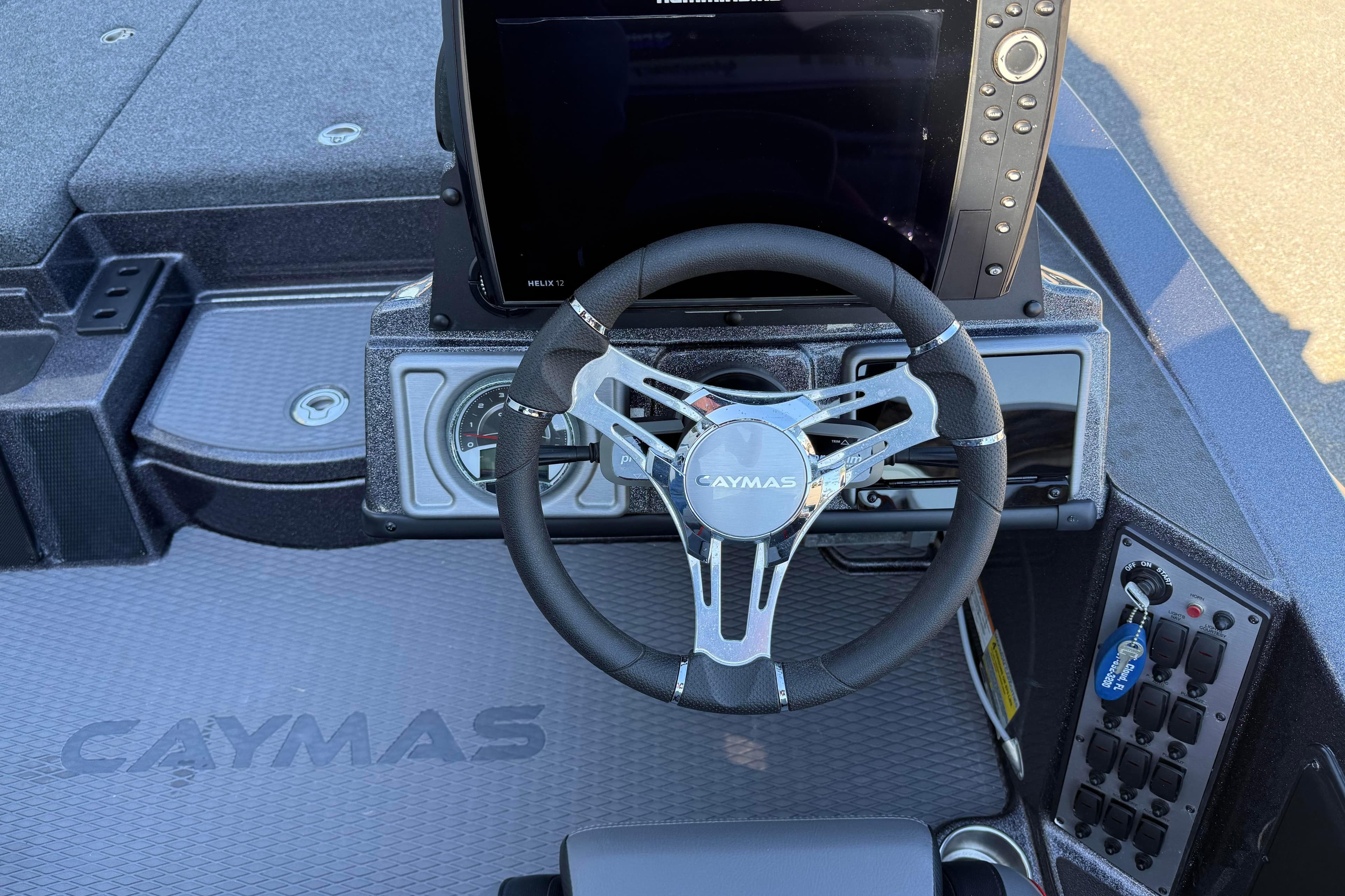 2022 Caymas CX 18 SS boat dashboard with steering wheel and control panel.