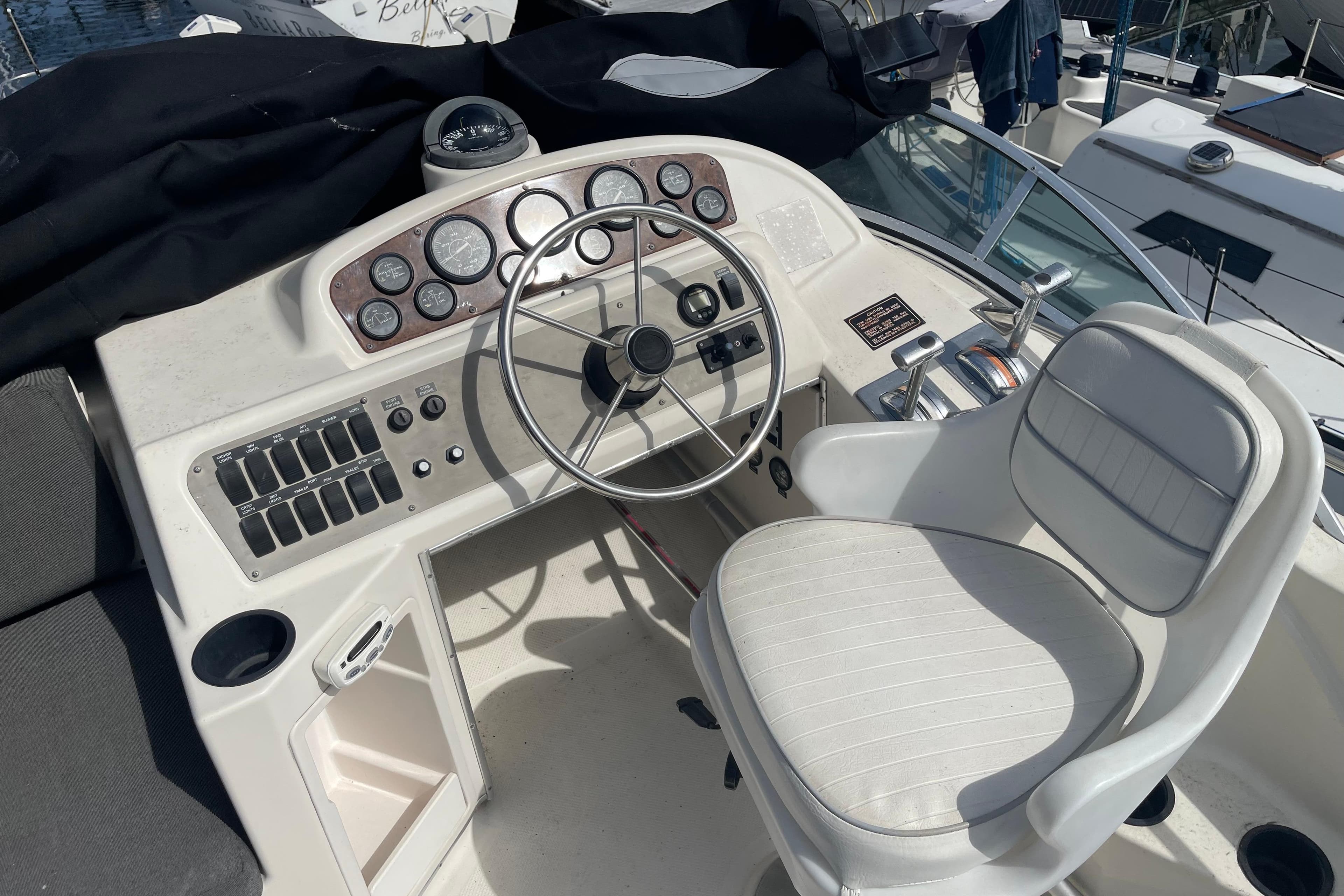Cockpit of 1996 Bayliner 3255 Avanti with steering wheel and control panel.
