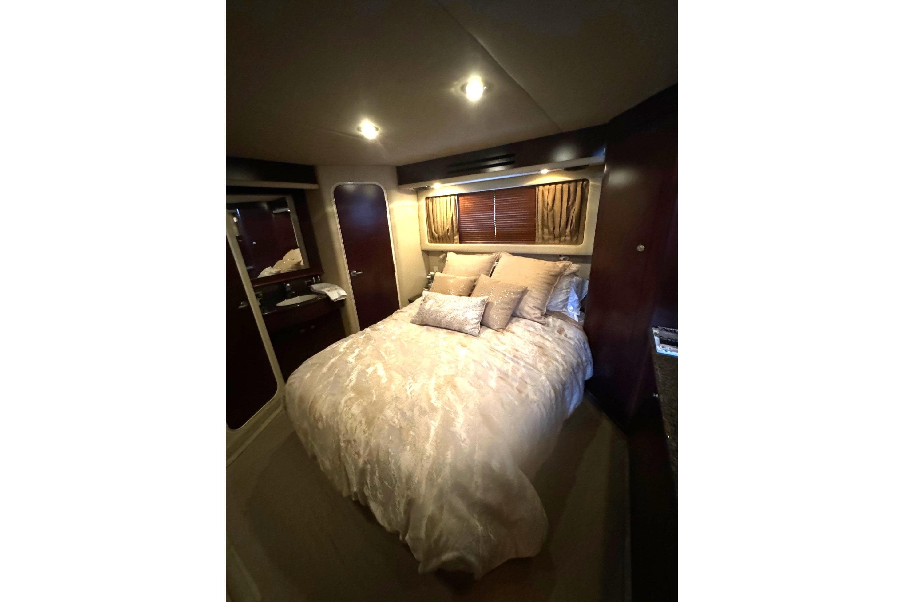 Luxurious bedroom interior of 2007 Sea Ray 40 Motor Yacht with elegant bedding.