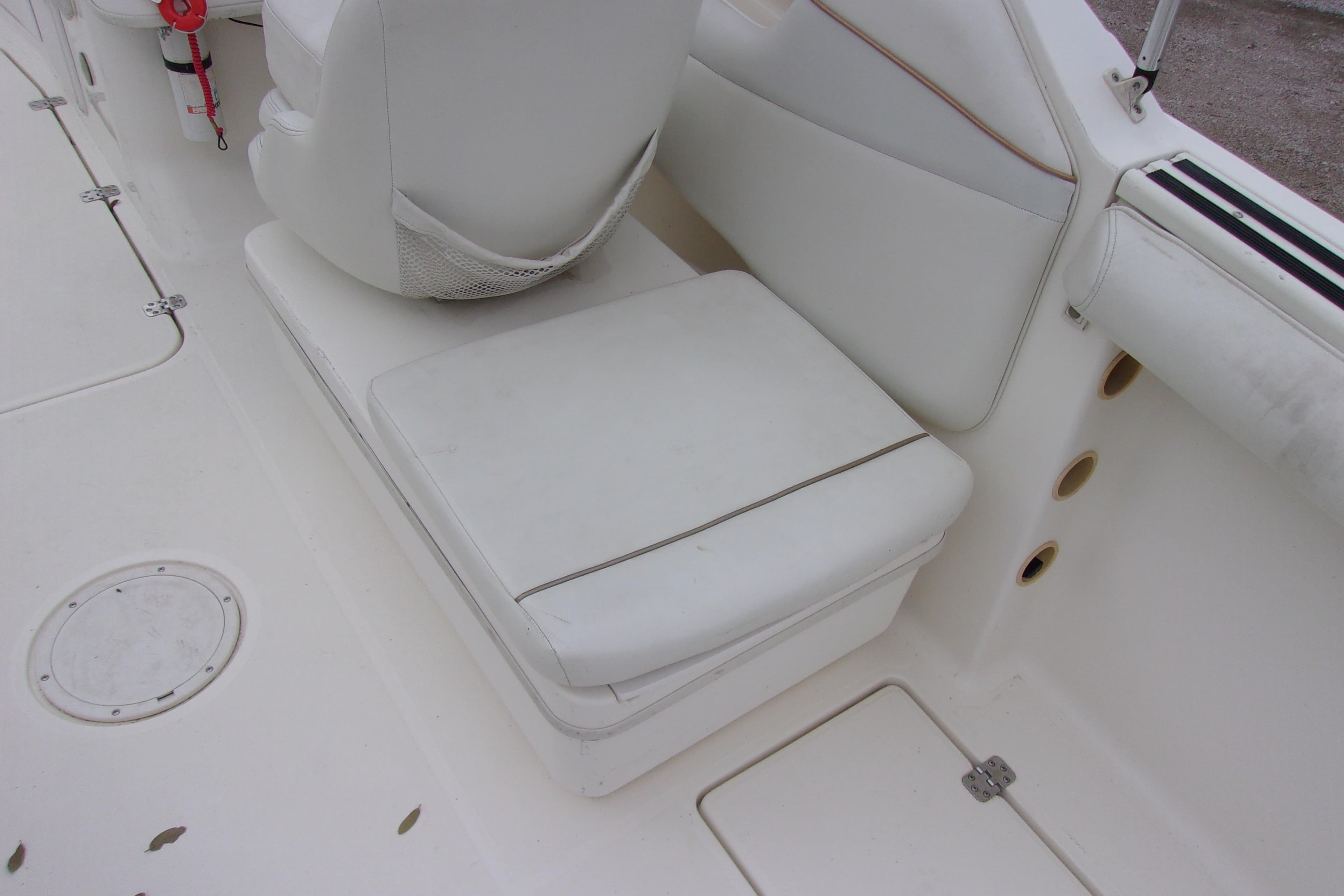 White seating area on a 1998 Wellcraft 210 Sportsman boat interior.