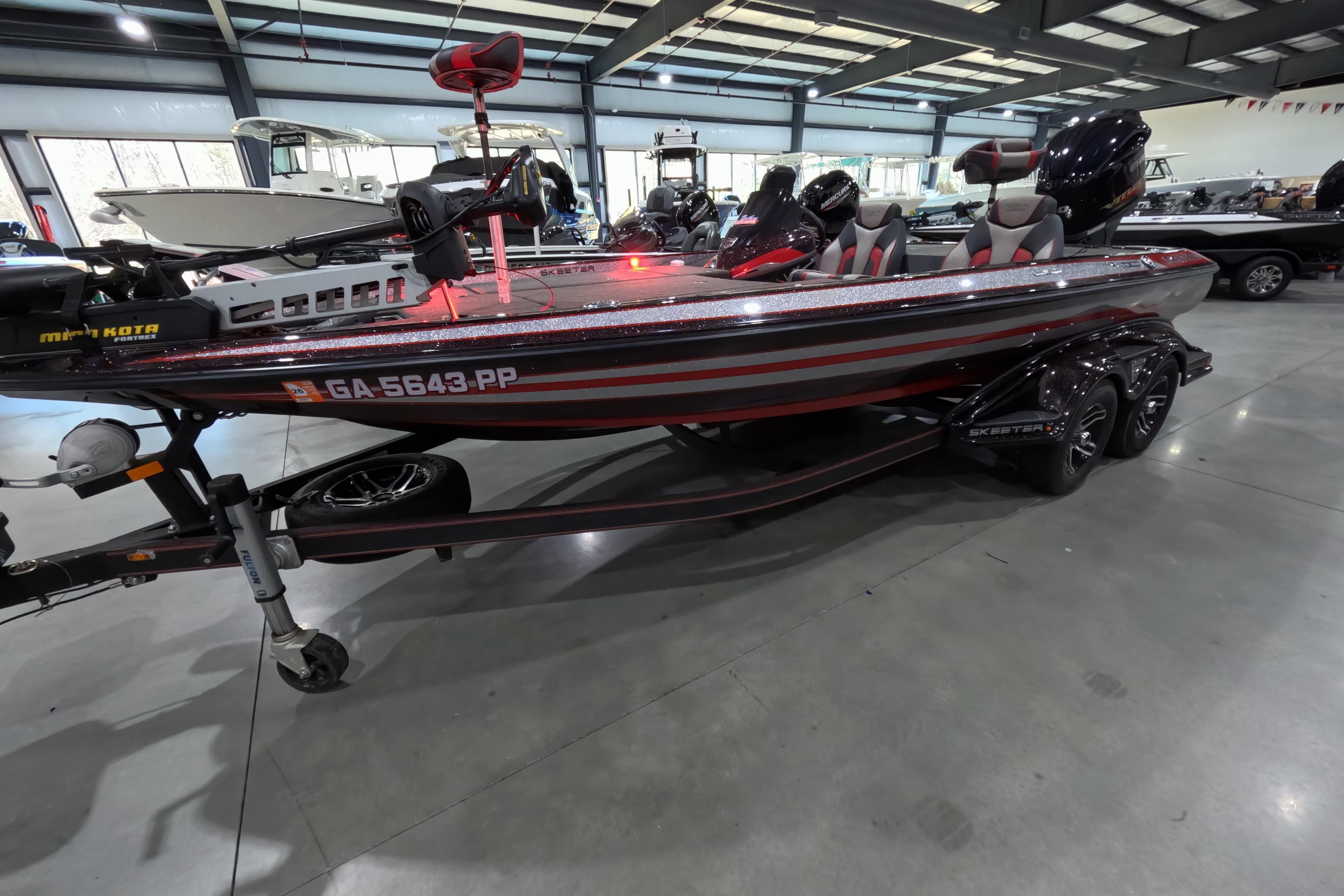 2017 Skeeter FX20 bass boat in showroom, featuring red and gray design.