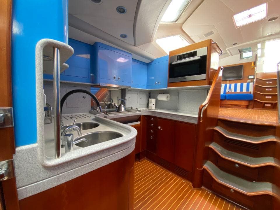 Luxurious Baltic 87 yacht interior kitchen with modern appliances and wooden finishes, 1996 model.
