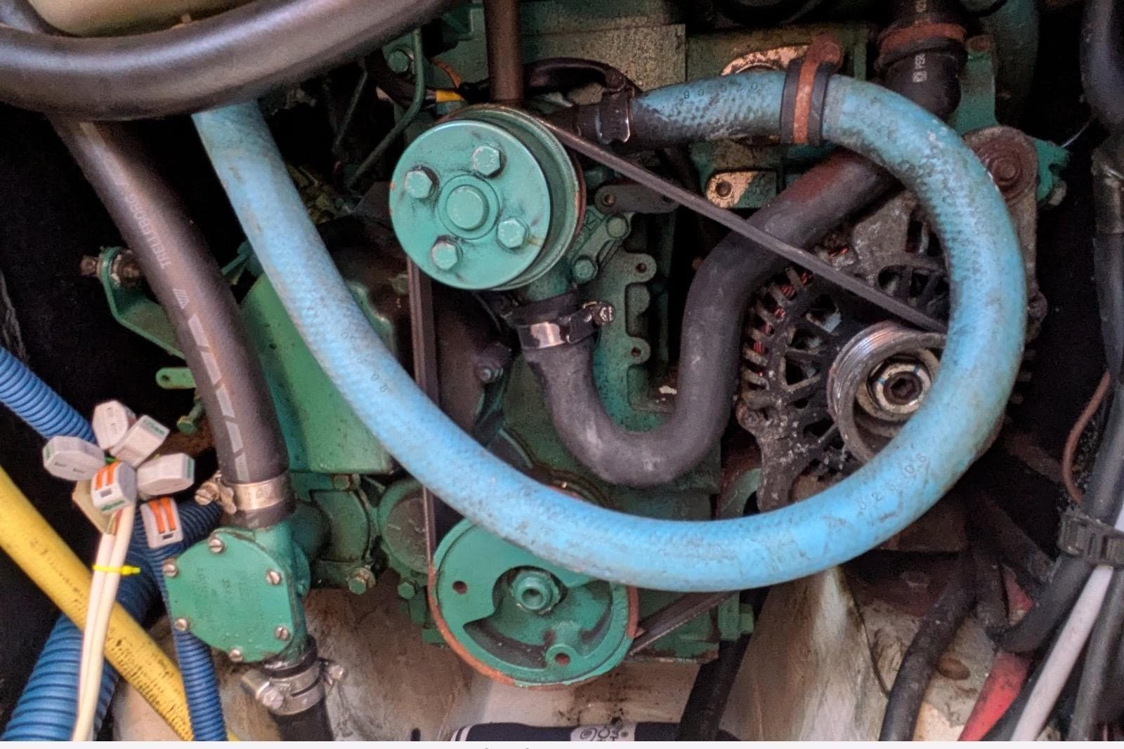 Engine components of a 2008 JPK 110, featuring hoses and belts in a compact arrangement.
