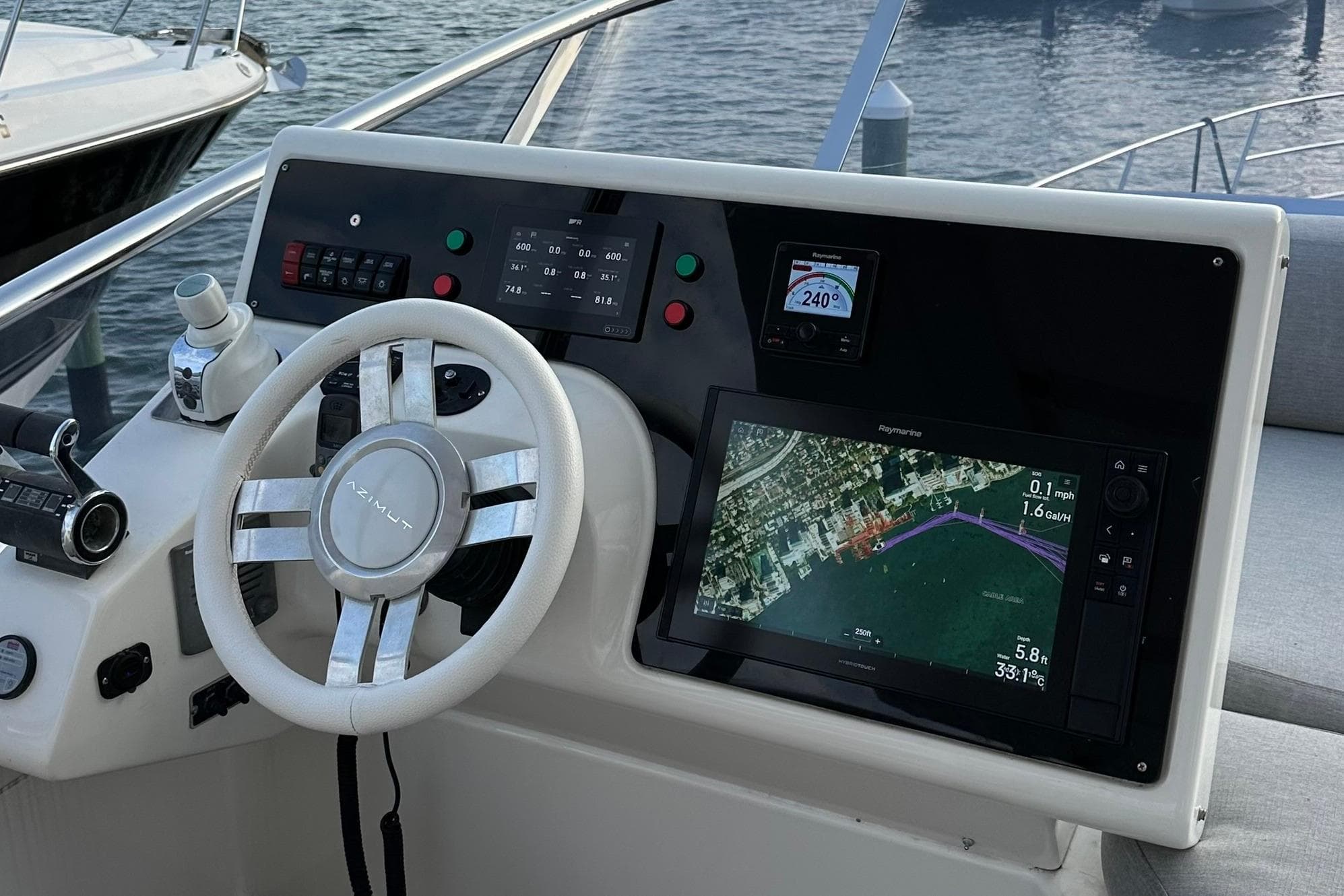 Cockpit of 2013 Azimut Fly 53 yacht with navigation display and steering wheel.