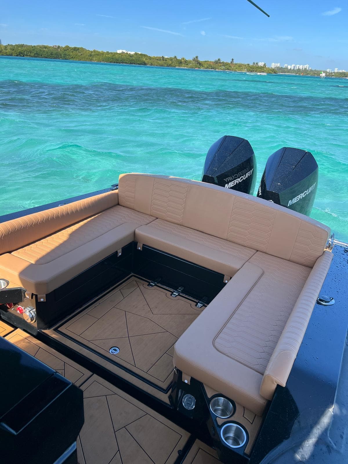 Luxurious Novielli Veloche 349 boat interior with tan seating, overlooking turquoise waters.