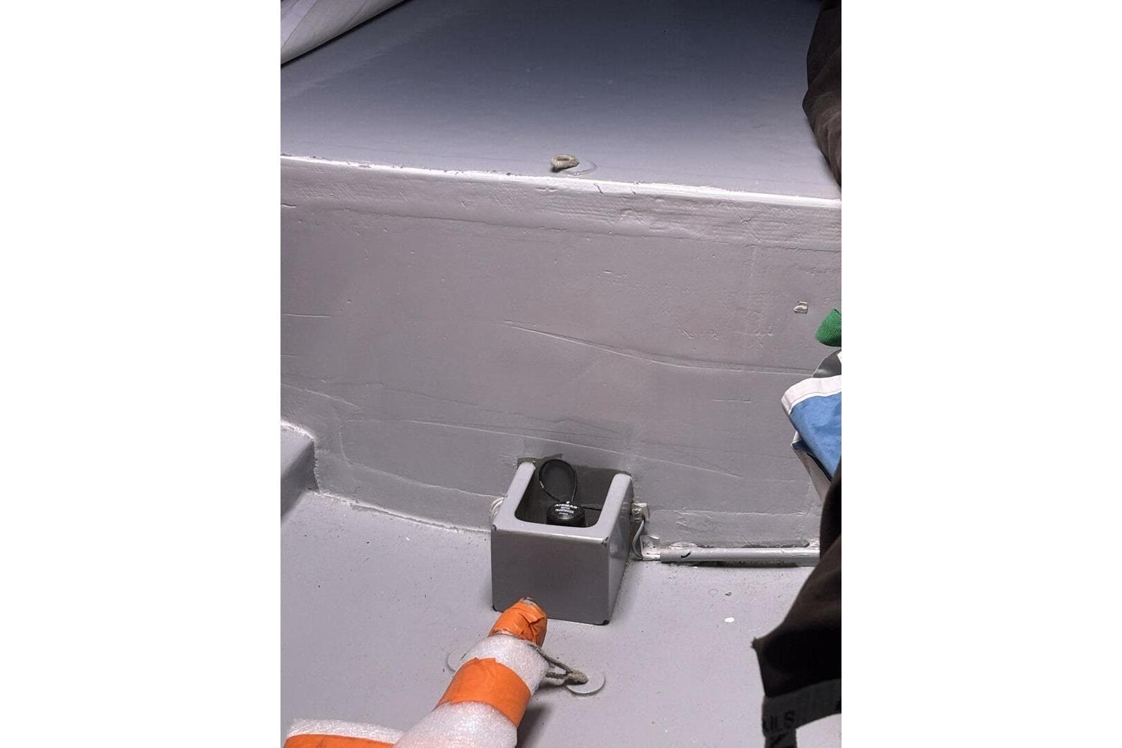Interior of 2009 Class 40 Akilaria RC2 sailboat, featuring a storage compartment and safety equipment.