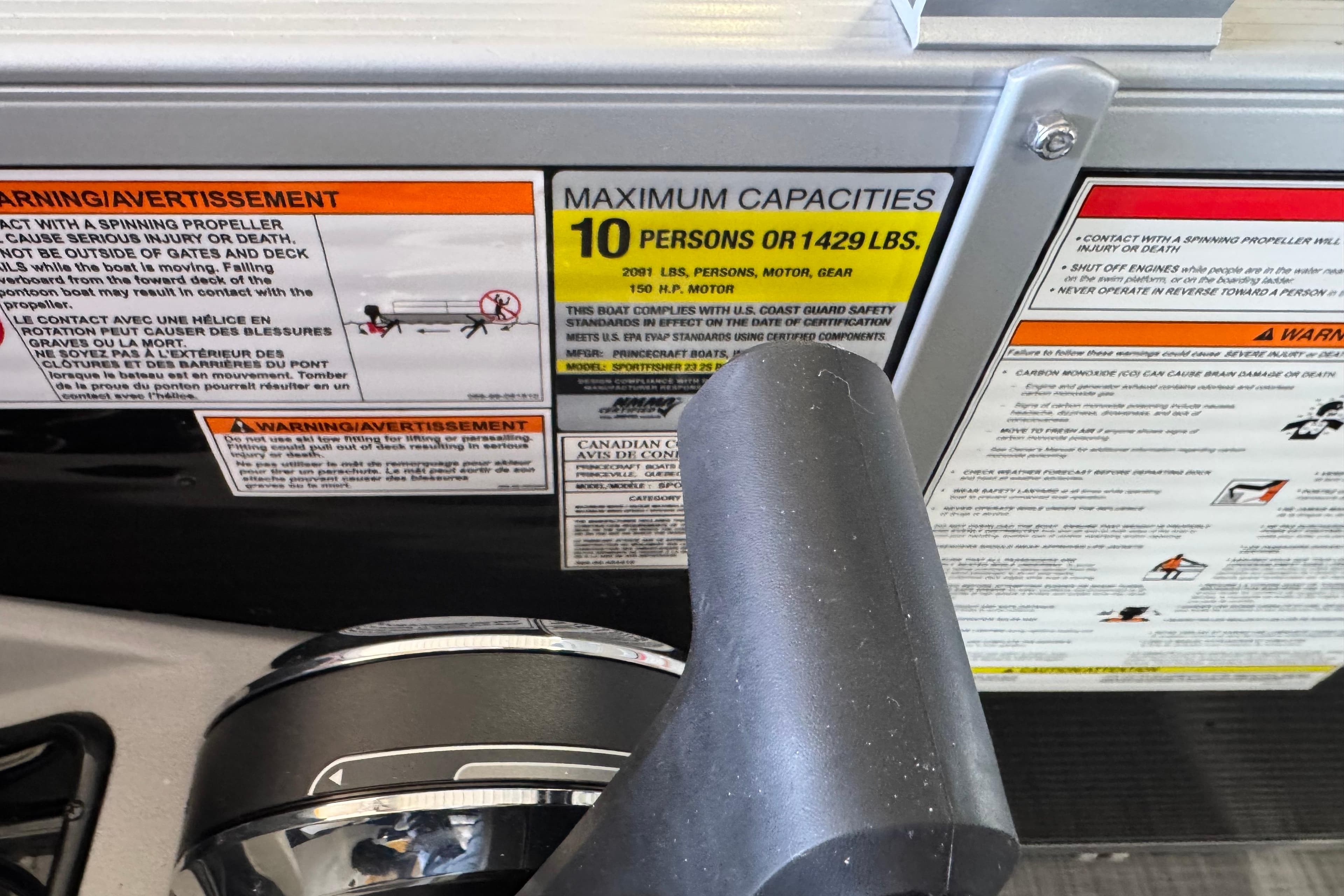 Warning labels on a 2026 Princecraft Sportfisher 23-2S RL boat, showing maximum capacity details.