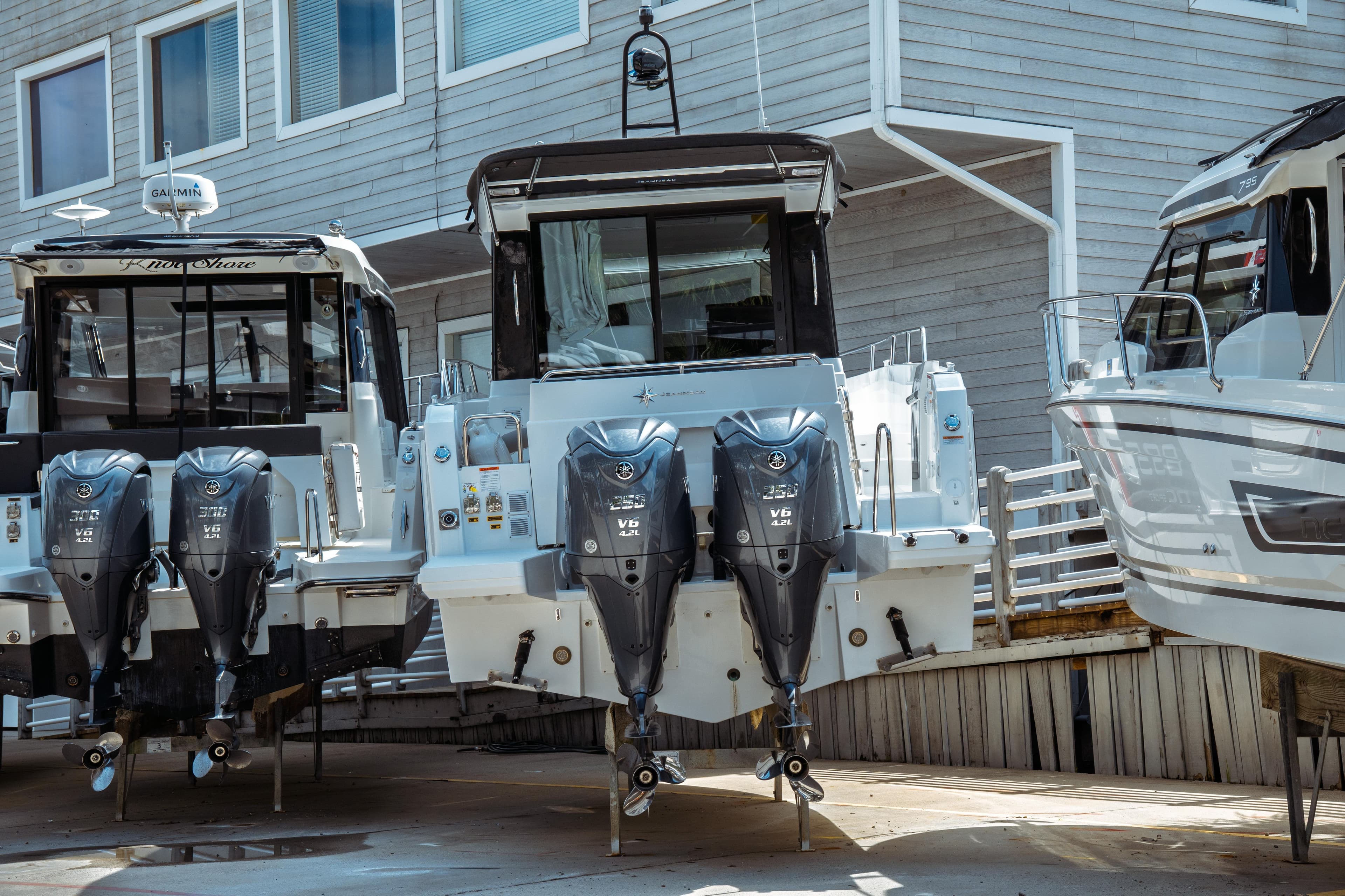 2025 Jeanneau NC 895 Sport Series 2 with dual outboard engines, docked at marina.