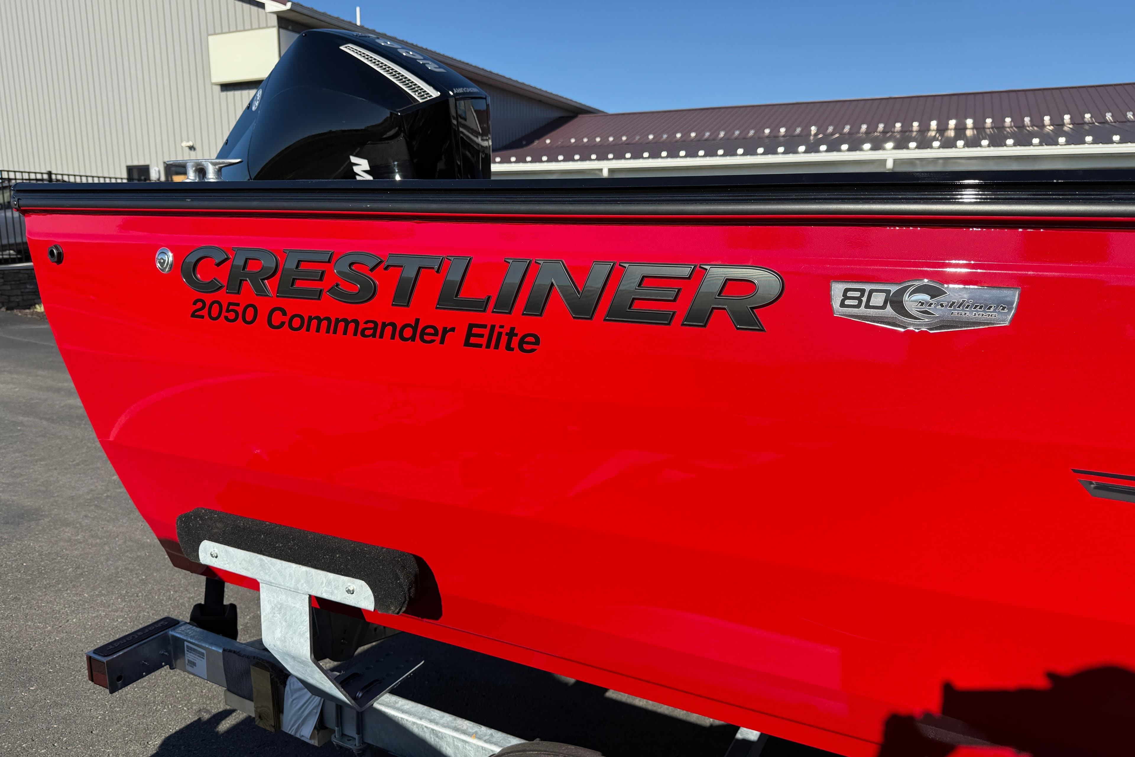 Red 2026 Crestliner 2050 Commander Elite boat on trailer, side view.